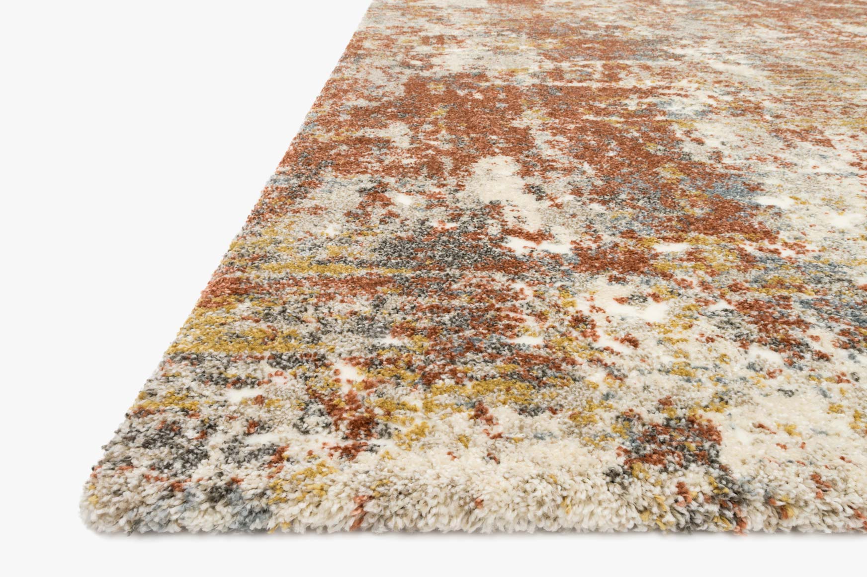 Rust, cream, and gray textured rug corner with short fringeless pile and abstract speckle.