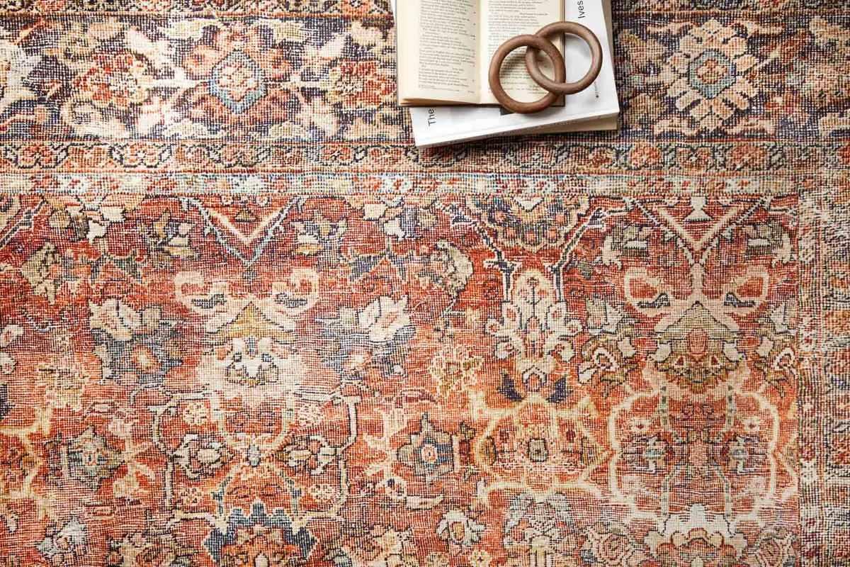 Close-up of spice-and-marine Persian-style rug pattern with detailed motifs