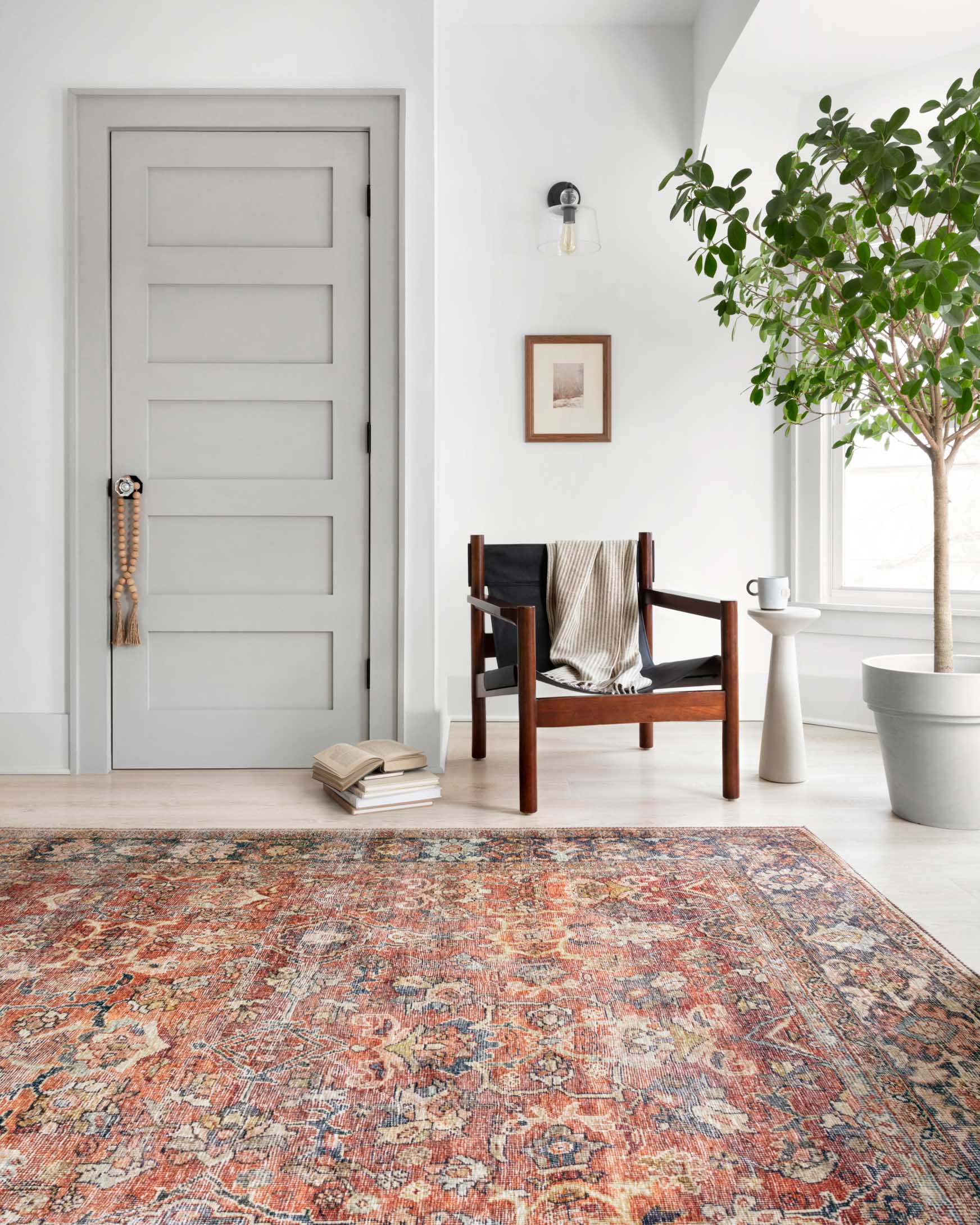 Spice-and-marine Persian-style rug with ornate border, laid on the floor