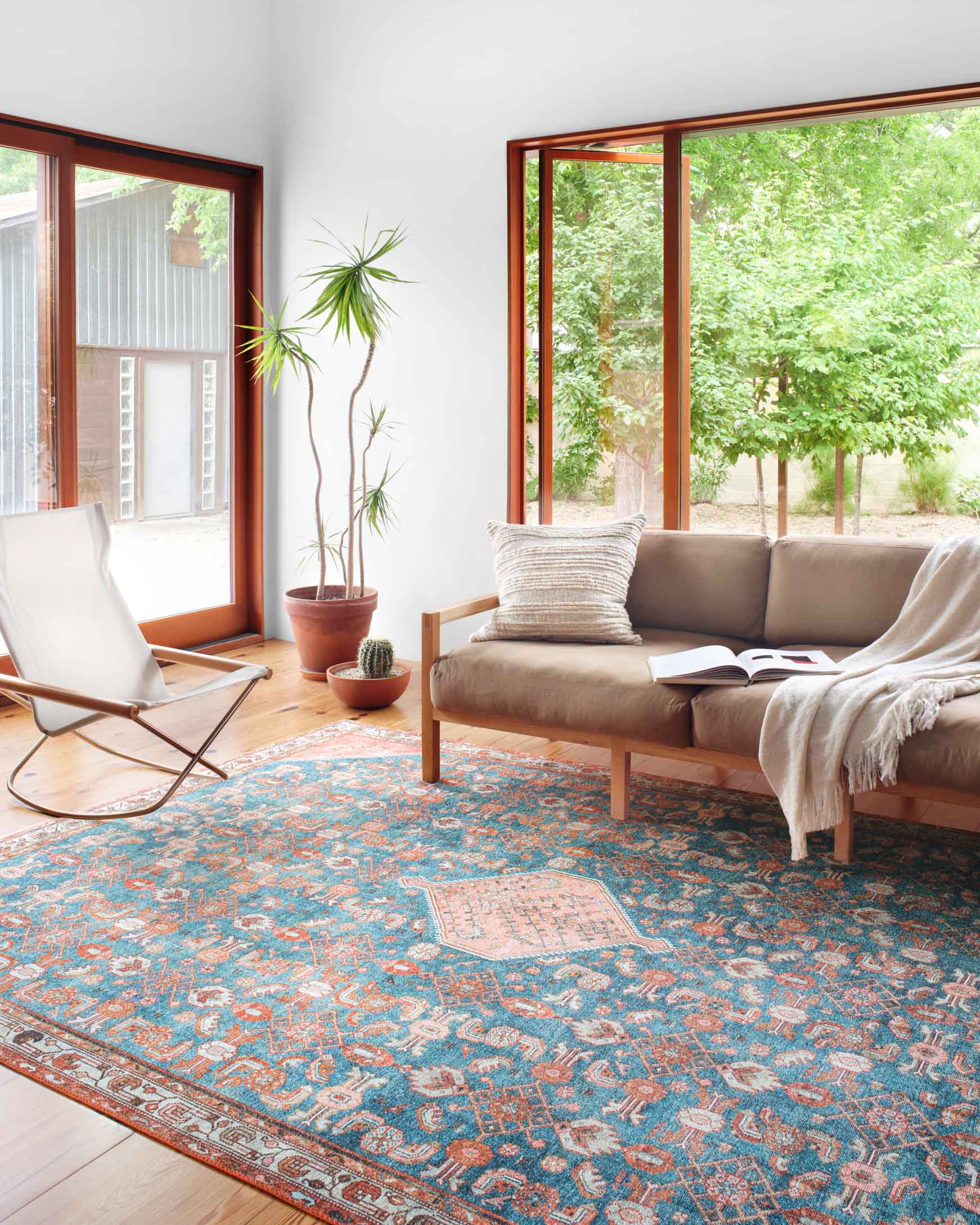 Traditional power-loomed rug in marine blue and clay red, ornate geometric pattern