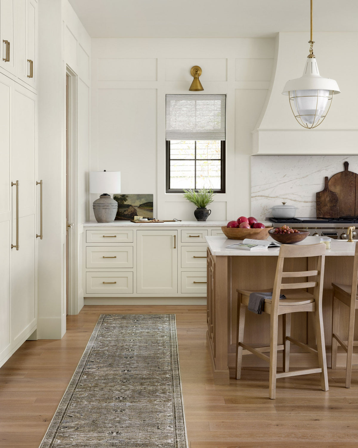 Narrow runner-style rug in antique grey with intricate ornamental border detailing.