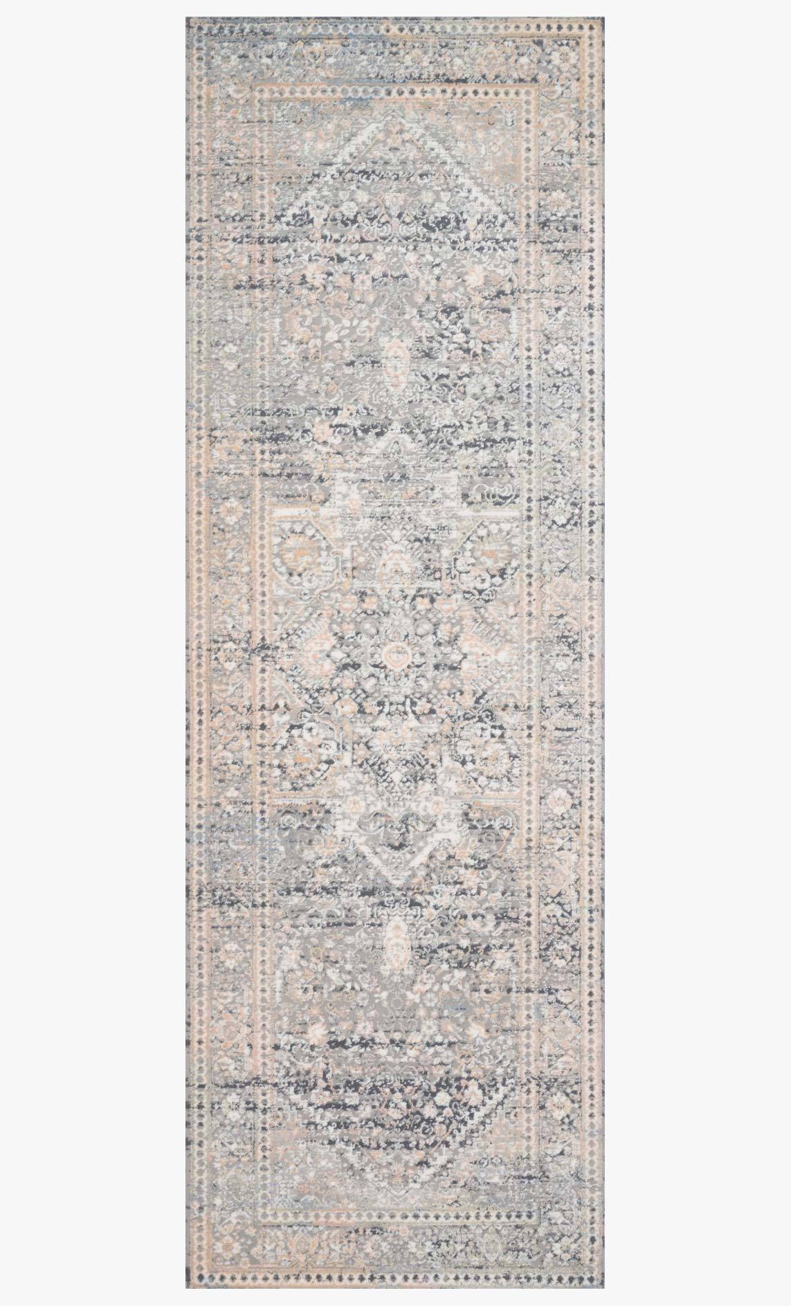 Rectangular light grey rug with distressed vintage-inspired medallion and border