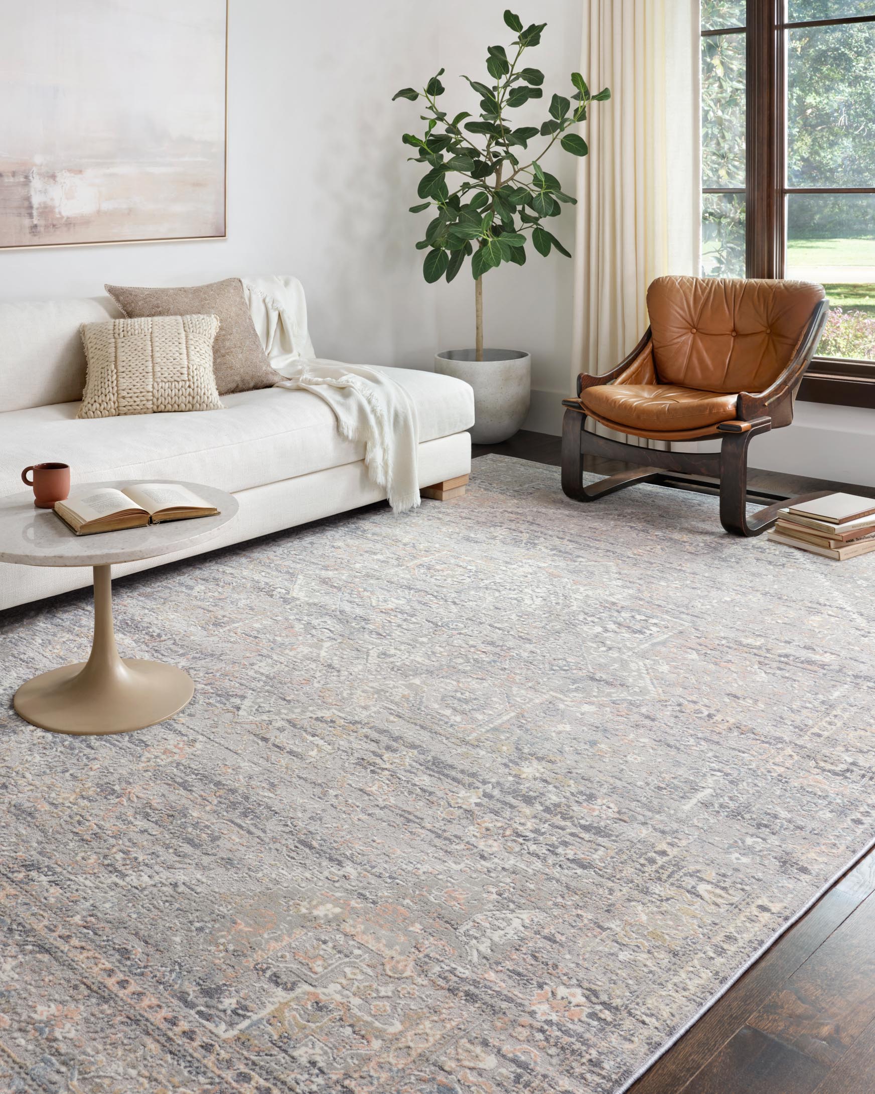 Light grey transitional rug with ornate pattern, styled on a living room floor