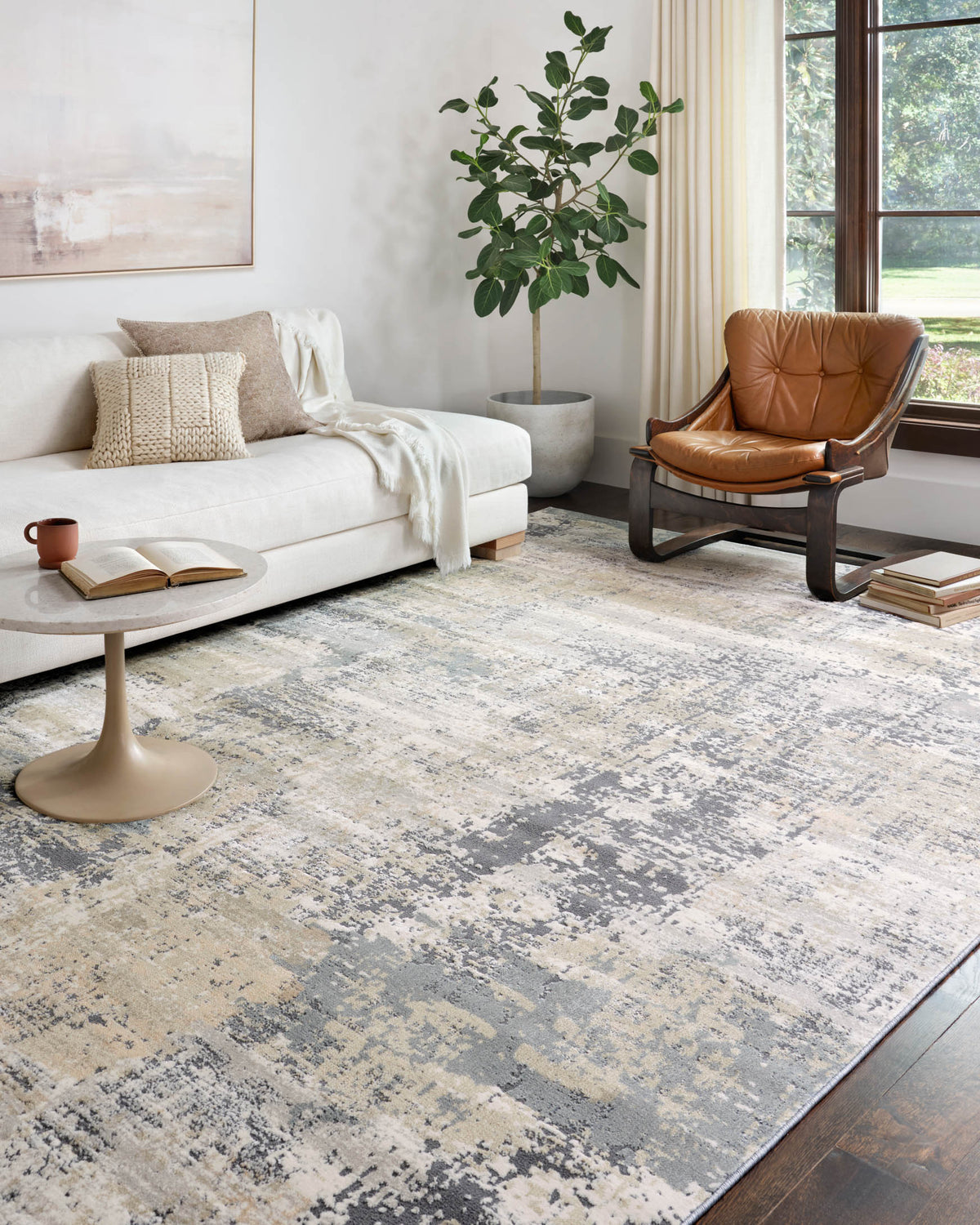 Transitional rug with distressed abstract gray-and-cream pattern on the floor