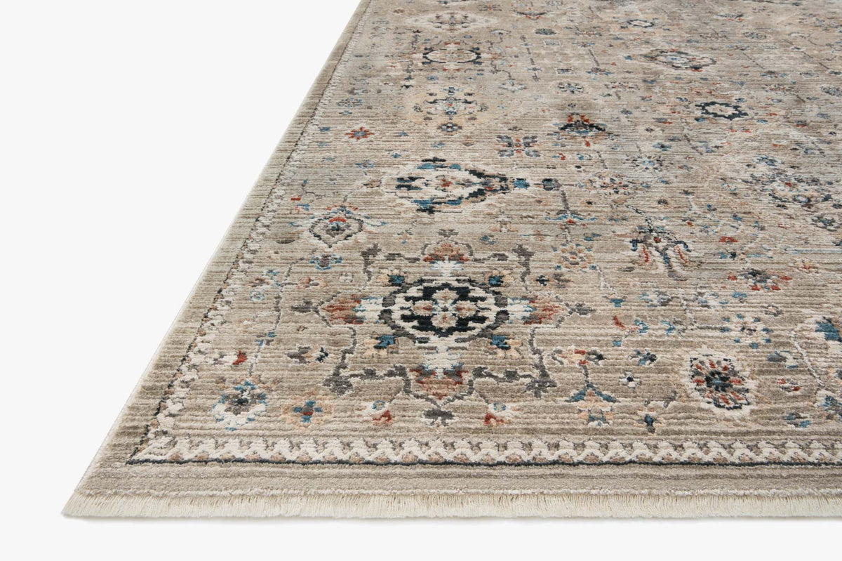 Power-loomed rug corner with dove background and distressed floral medallion design; short fringe.