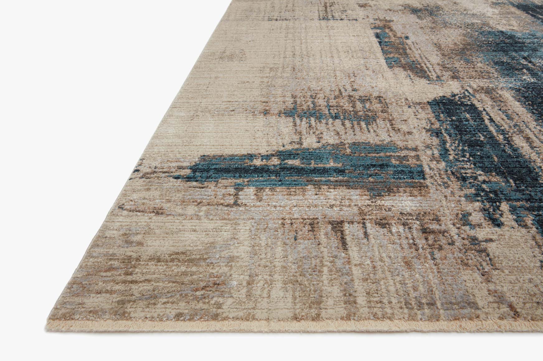 Rectangular power-loomed rug in slate and denim, distressed abstract pattern, corner view.