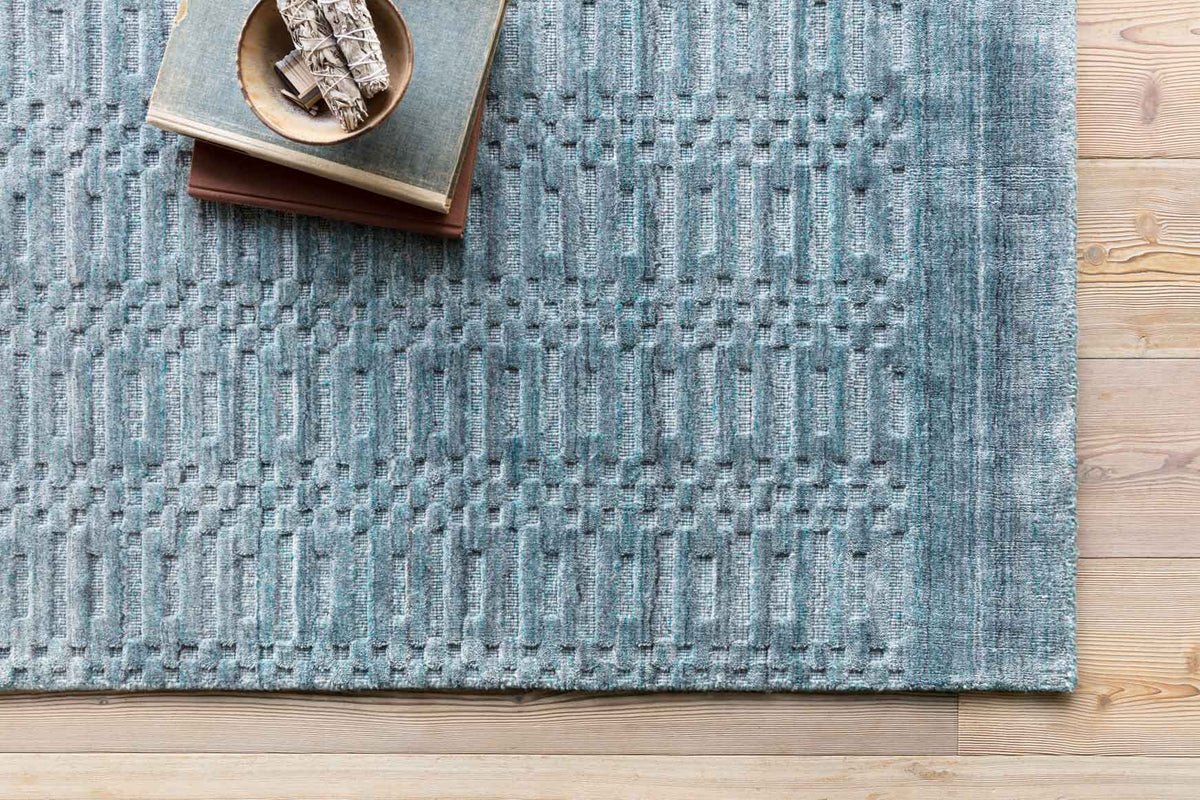 Ocean blue rug close-up with textured raised lattice weave and woven surface.