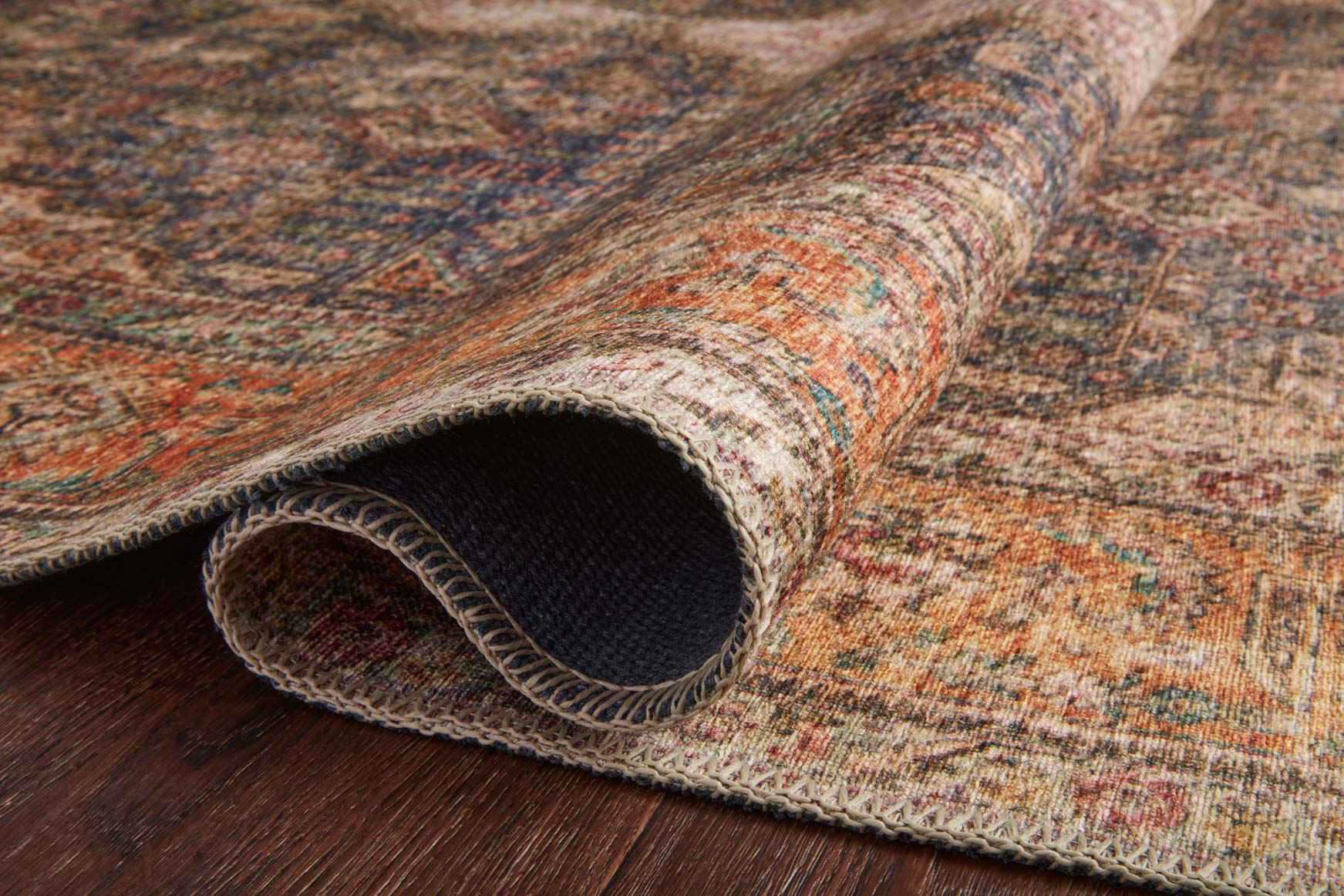Traditional rug rolled edge showing woven texture and dark backing