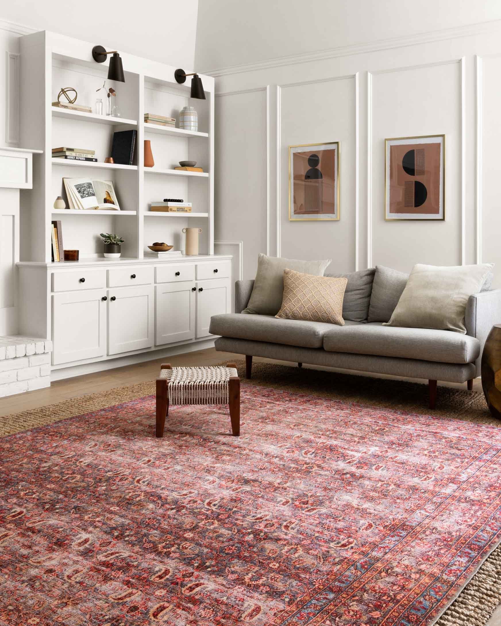Traditional area rug in red, blue, and cream with ornate vintage-style border