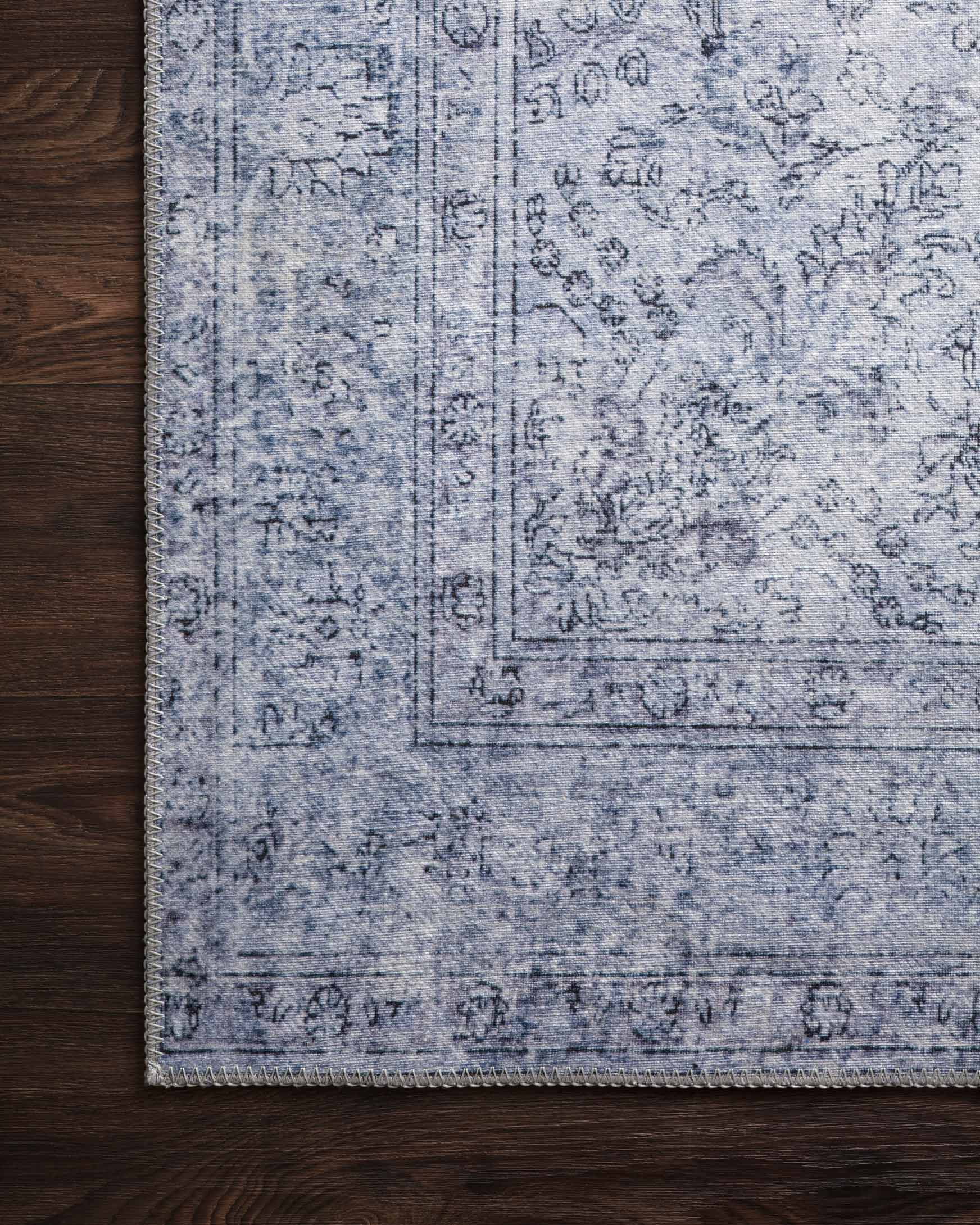 Slate blue traditional area rug with distressed pattern and flat woven texture