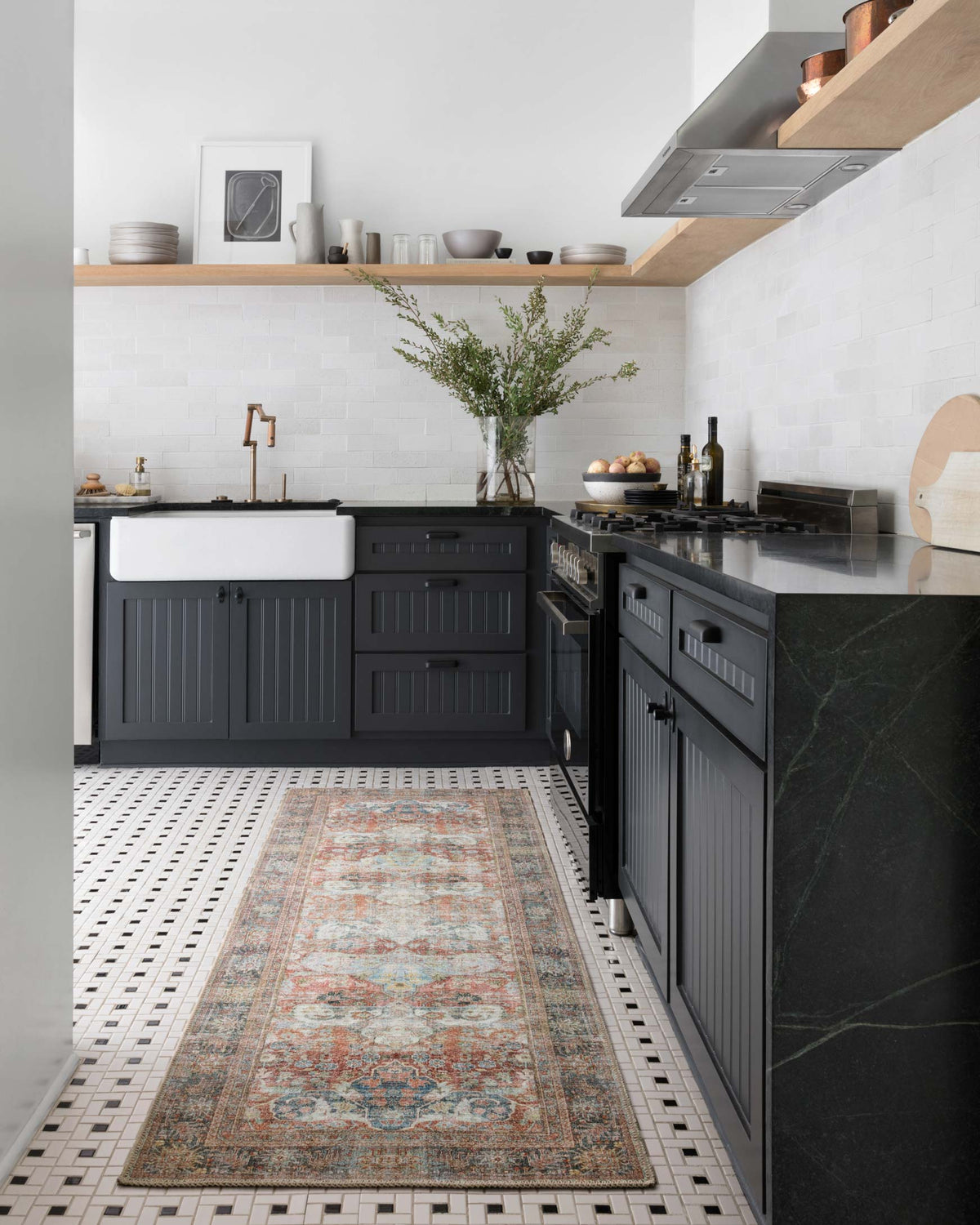Traditional rug runner in modern kitchen, multi-color ornate design in brick and blue tones.