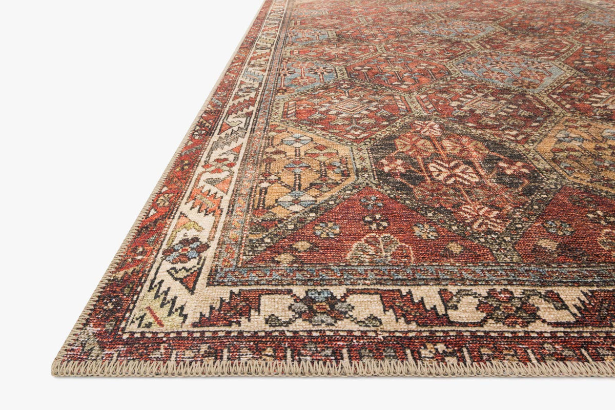 Corner view of spice red traditional rug with detailed geometric motifs and border