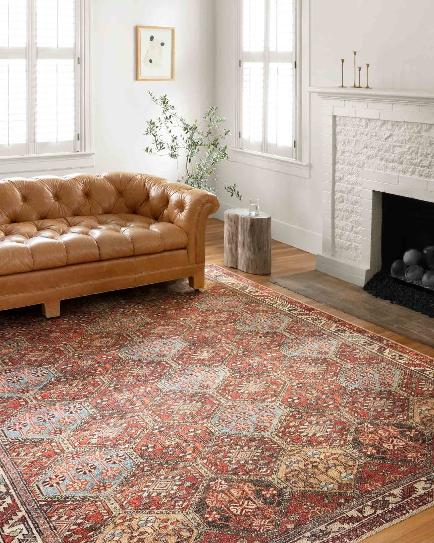 Traditional rug in spice red with ornate geometric medallion pattern and multicolor border