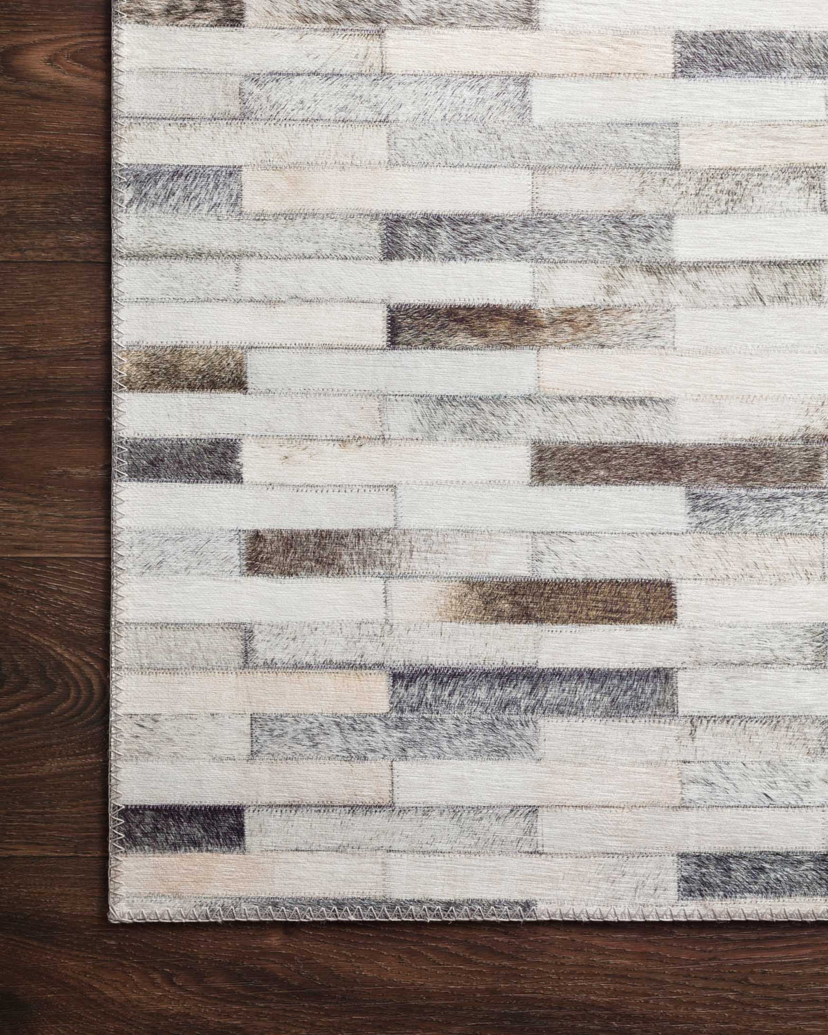 Ivory and grey rug with textured horizontal stripe blocks and stitched border.
