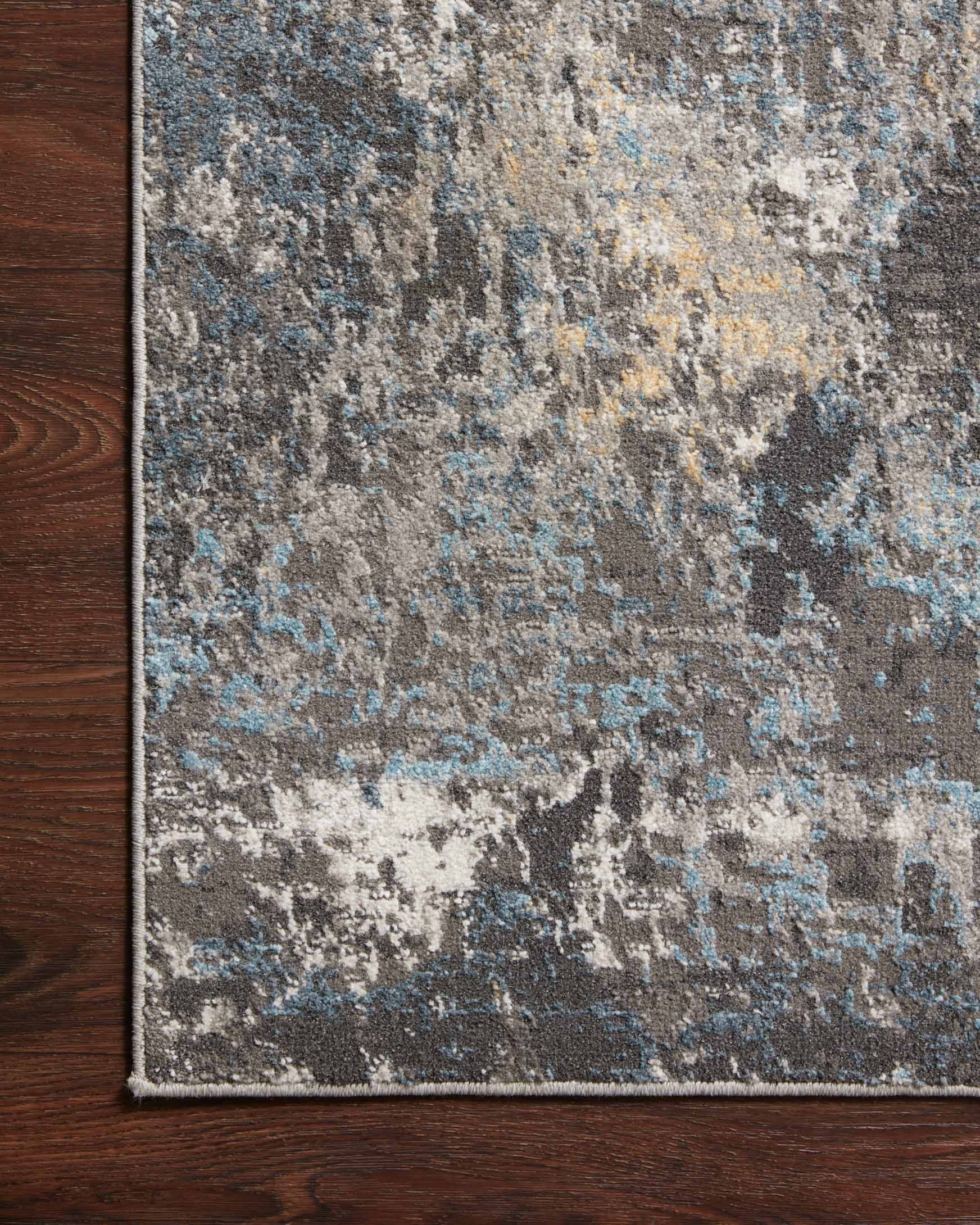 Silver and slate abstract rug edge detail with textured pile