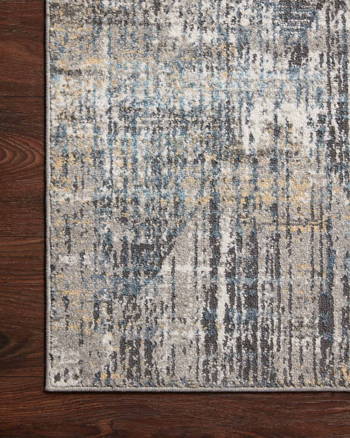 Close-up of granite-and-mist area rug with blue-gray and beige abstract texture