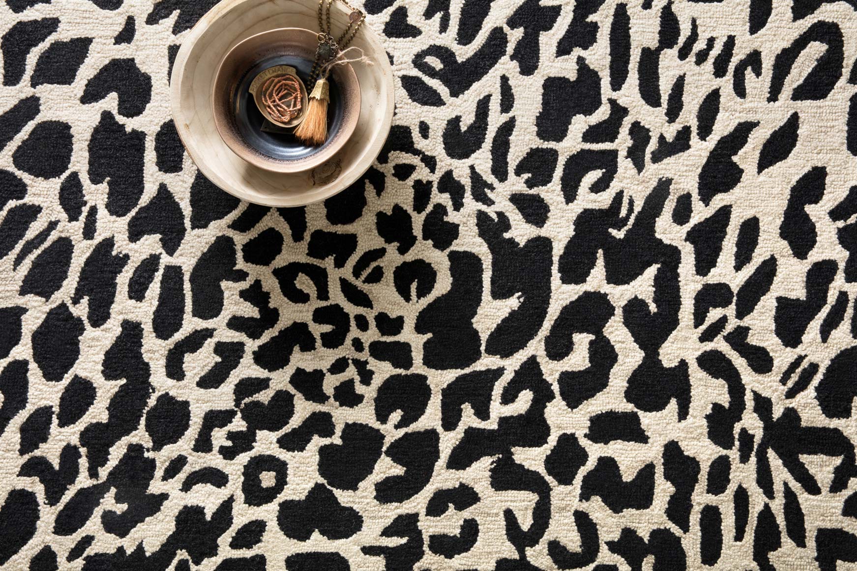 Black and ivory leopard print rug with top-down view