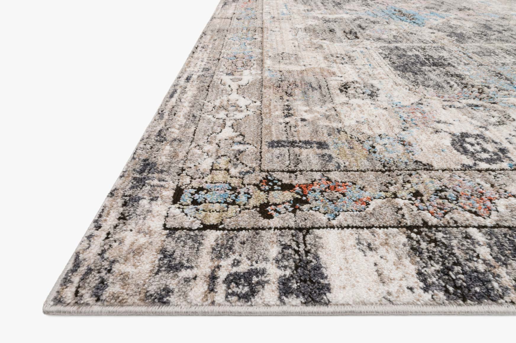 Corner view of contemporary rug in natural beige and gray with abstract motifs and blue accents