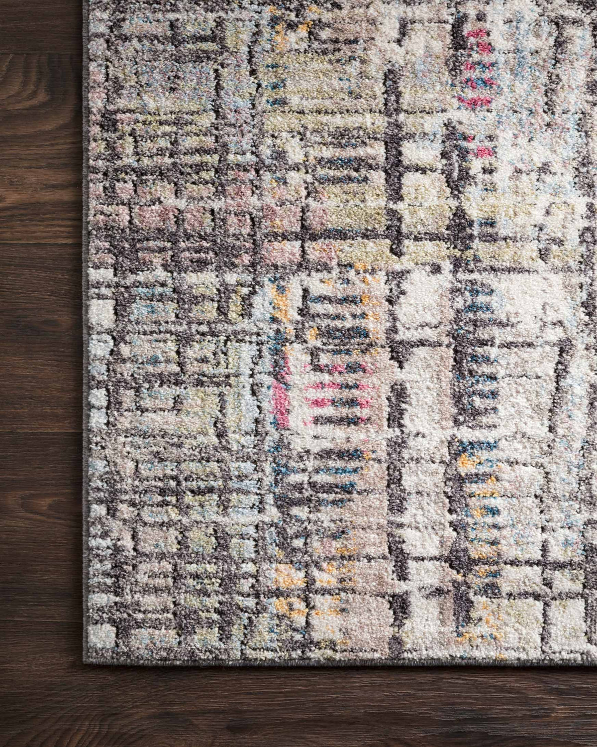 Power-loomed rug close-up with charcoal, ivory and multicolor geometric line pattern