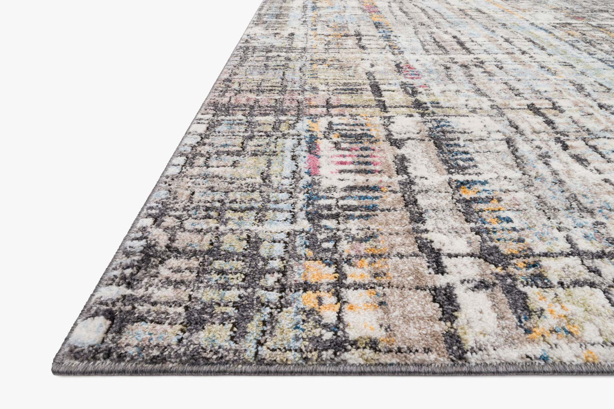 Power-loomed rug corner view in charcoal and ivory with multicolor abstract blocks