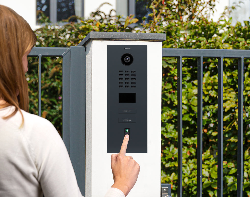 Outdoor fingerprint video door station panel with finger pressing the call button