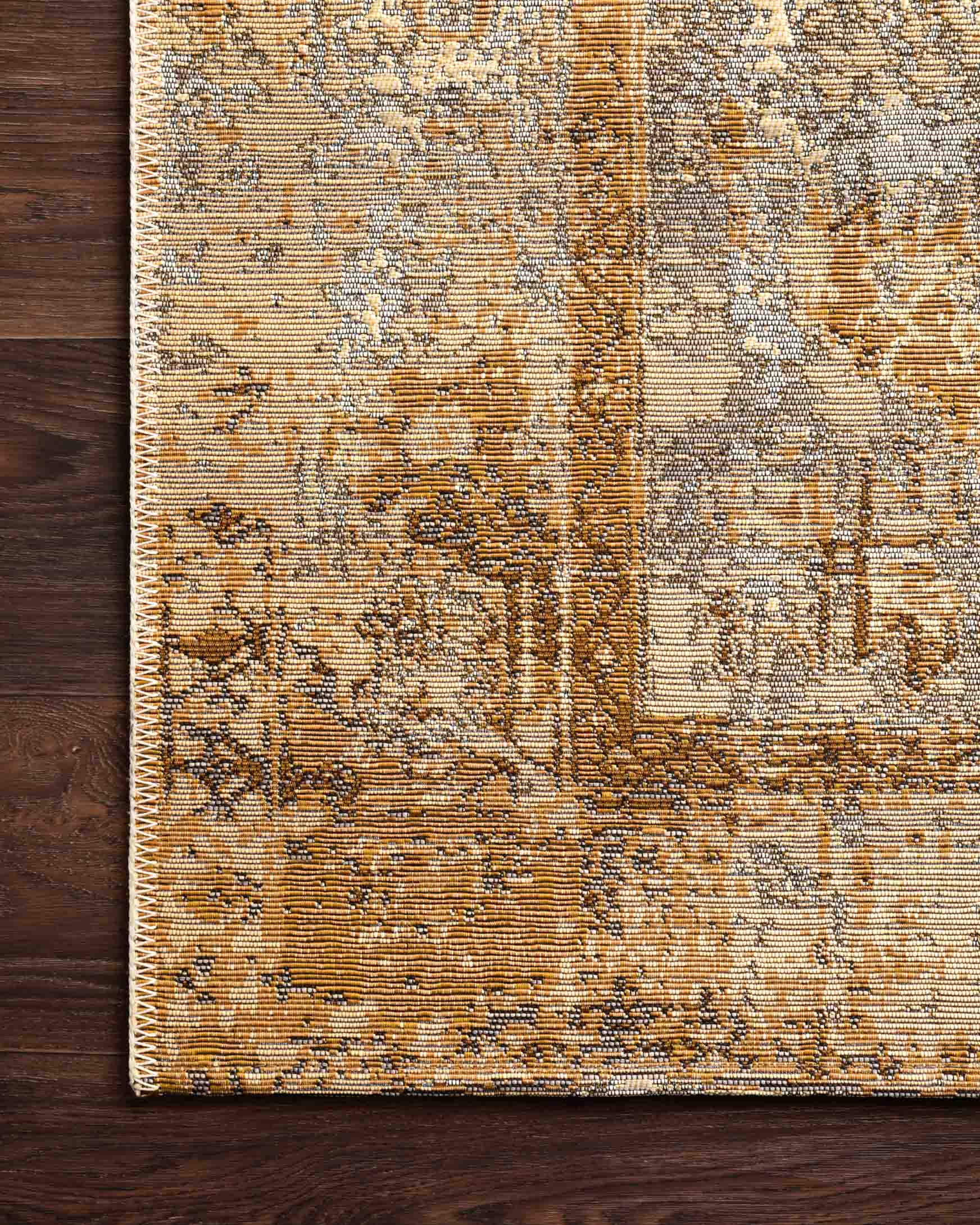 Corner close-up of indoor/outdoor power loomed rug in antique ivory and copper weave