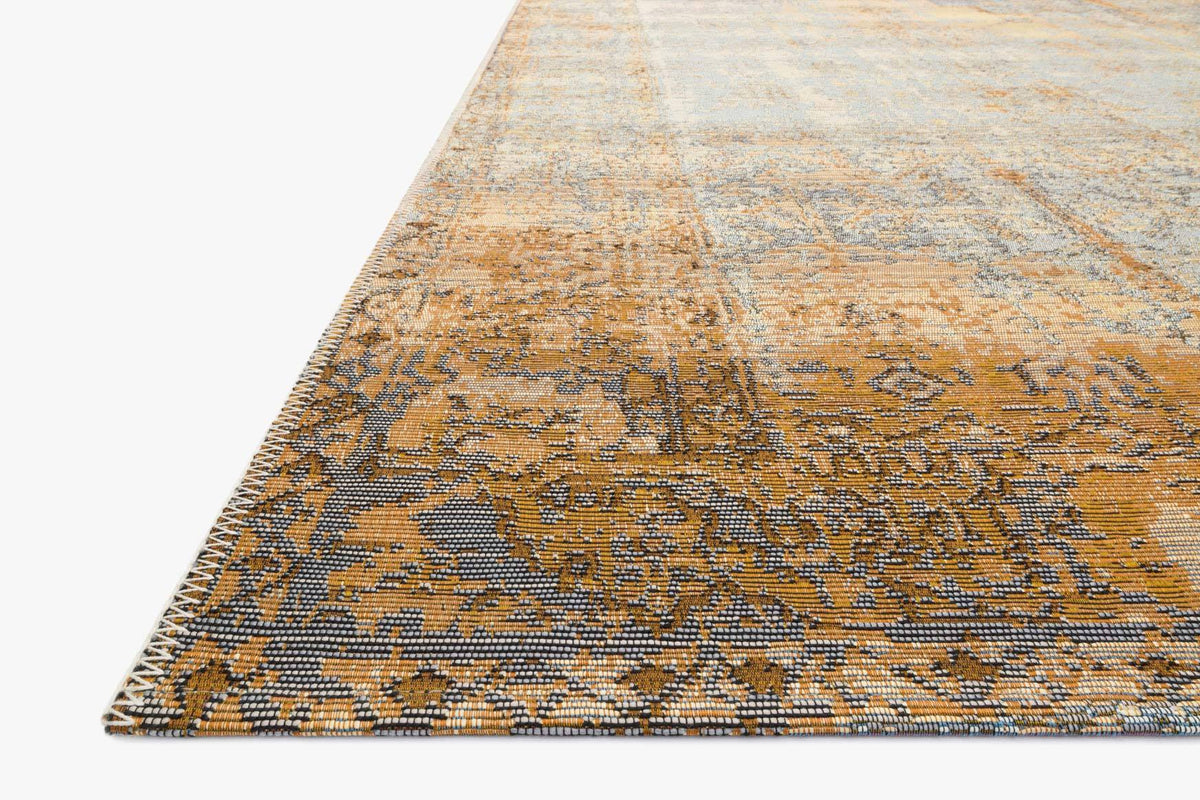 Corner edge view of indoor/outdoor power loomed rug in antique ivory and copper