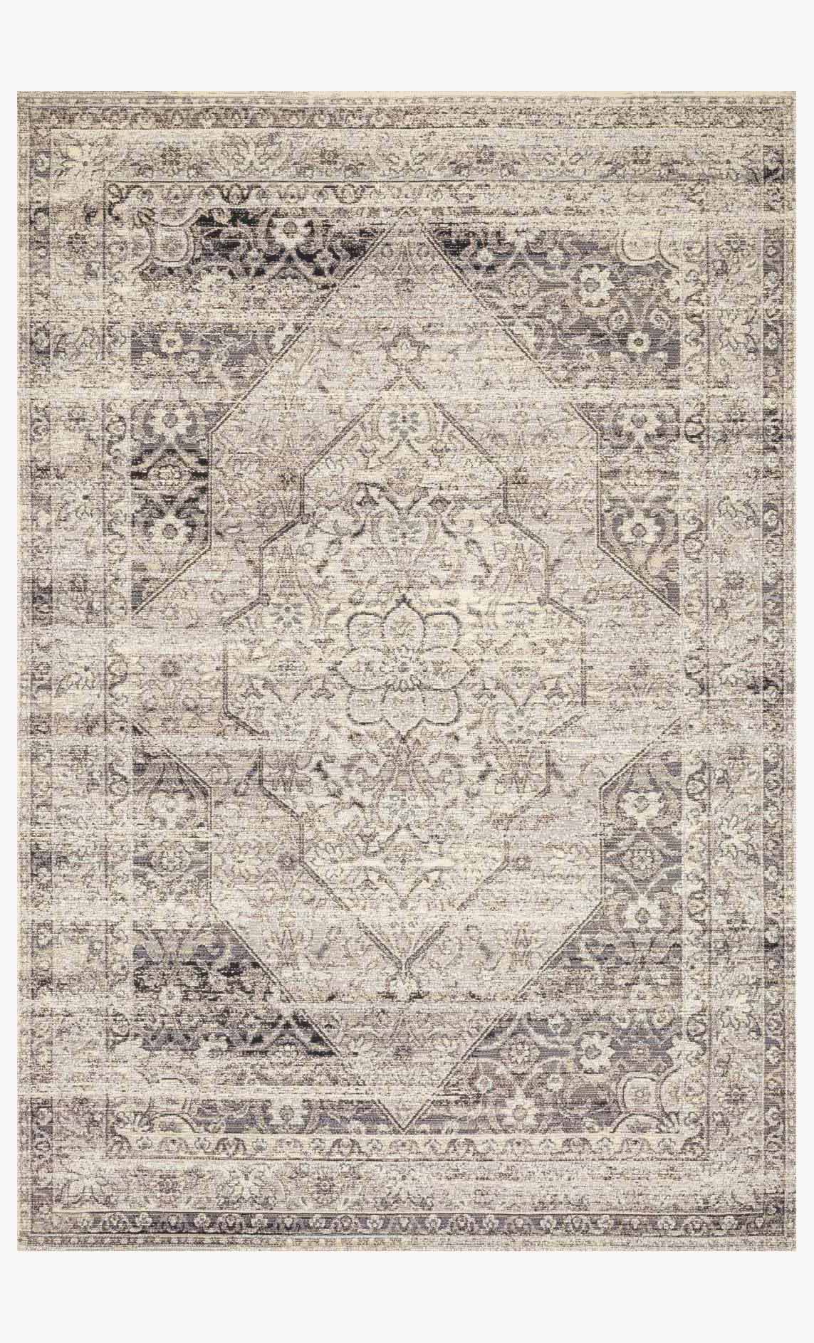 Stone-and-ivory indoor/outdoor power-loomed rug with ornate geometric medallion border.