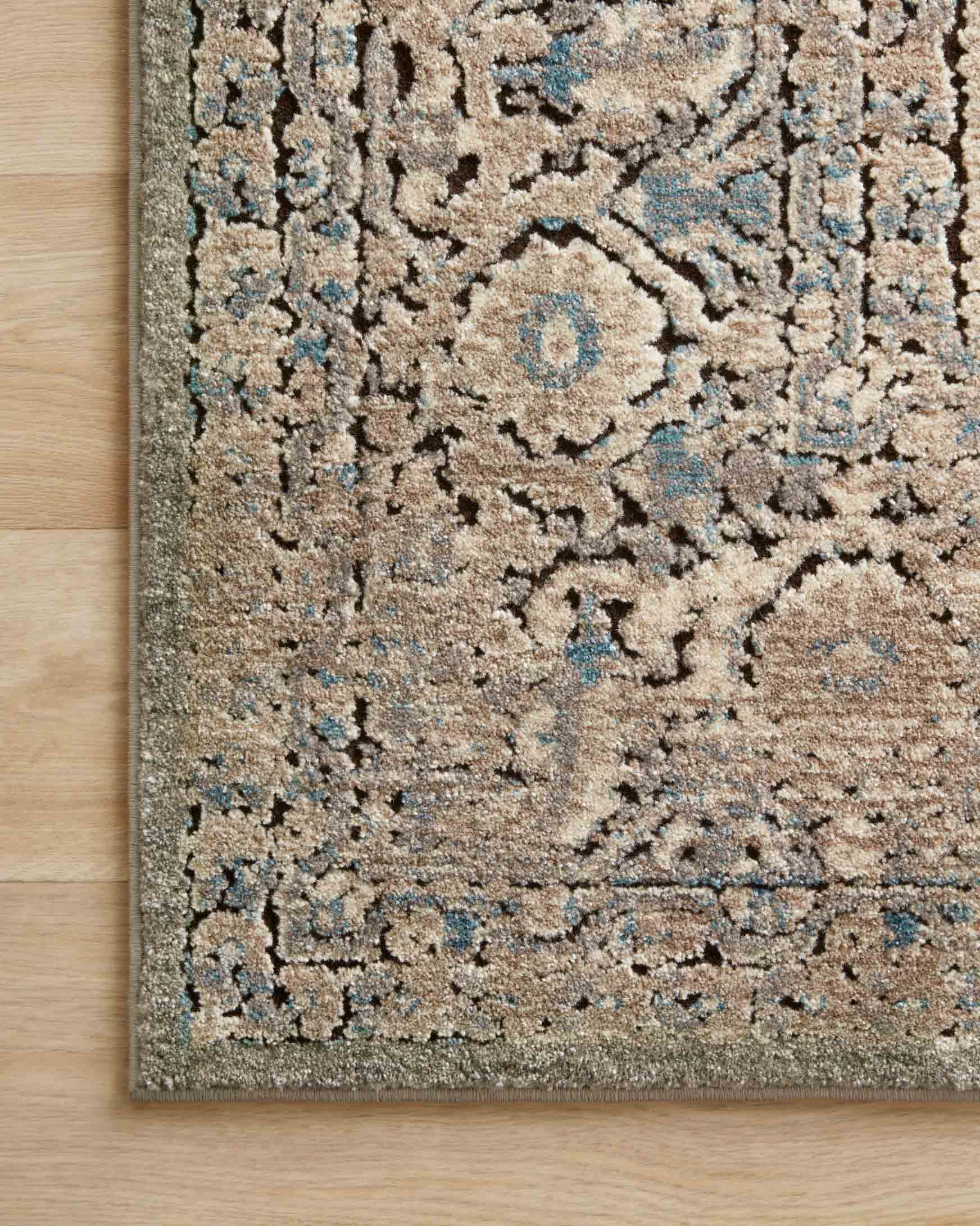 Power-loomed transitional rug with abstract medallion pattern, grey/stone and blue accents