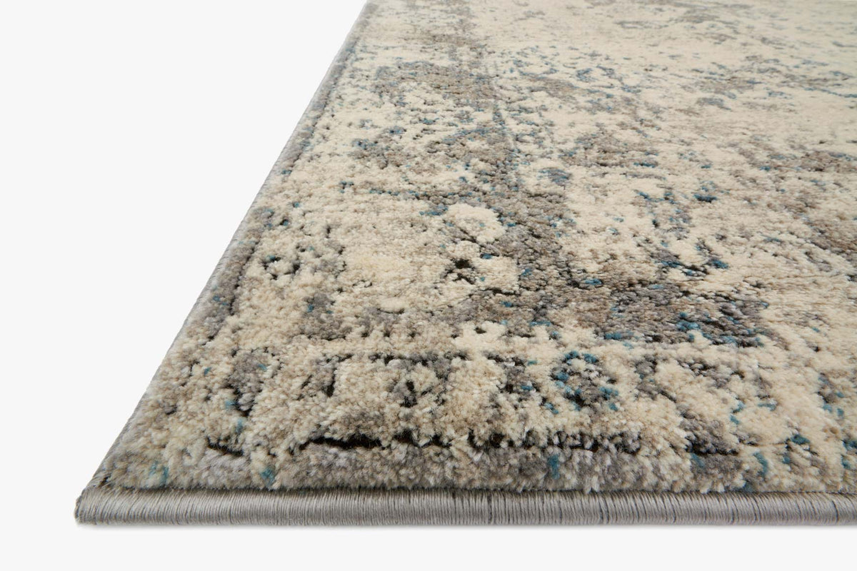 Ivory and grey power-loomed rug close-up showing textured pile and abstract motifs