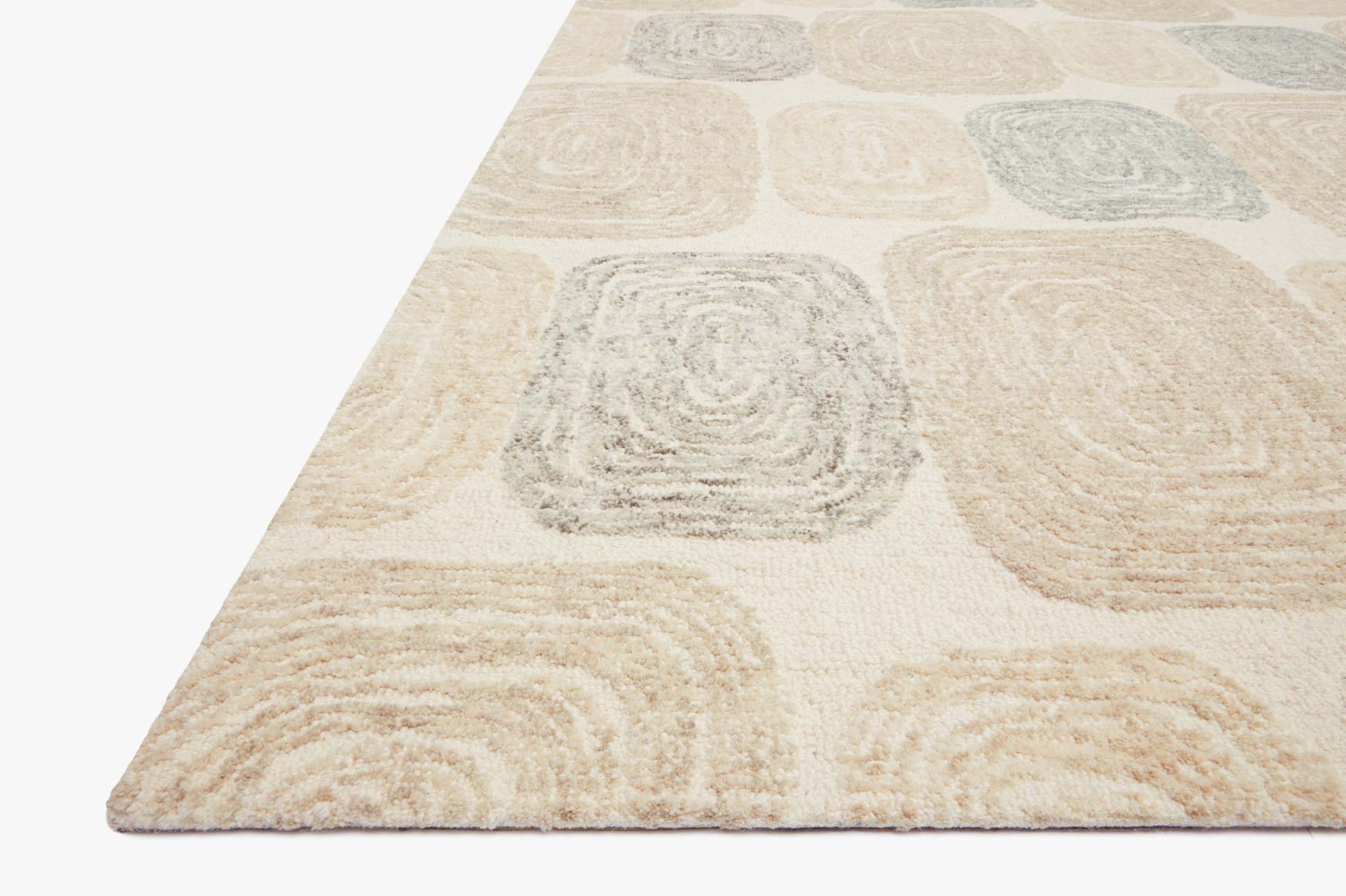 Hand-tufted rug corner with cream base and gray swirled square designs