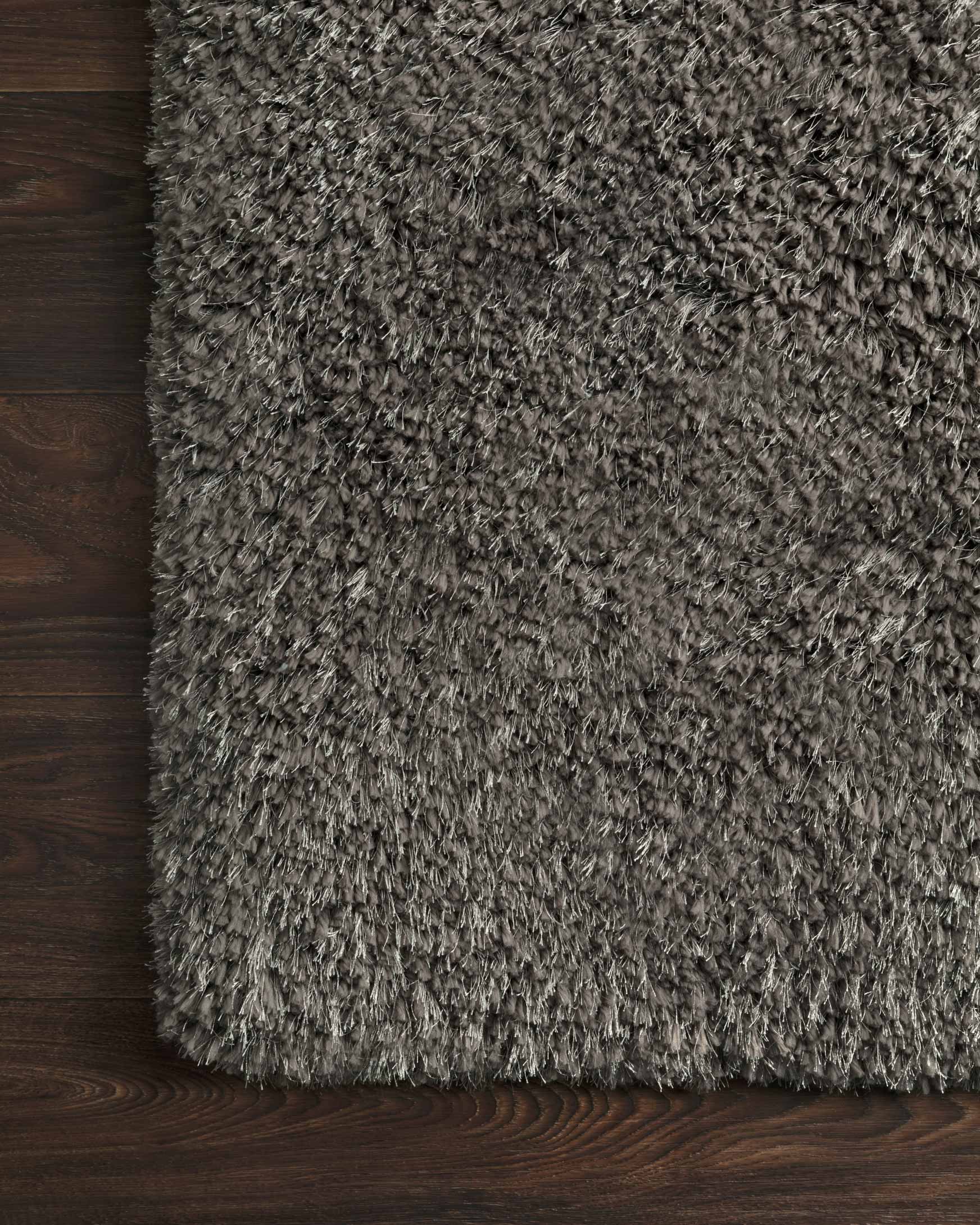 Charcoal shag rug corner detail with dense pile texture