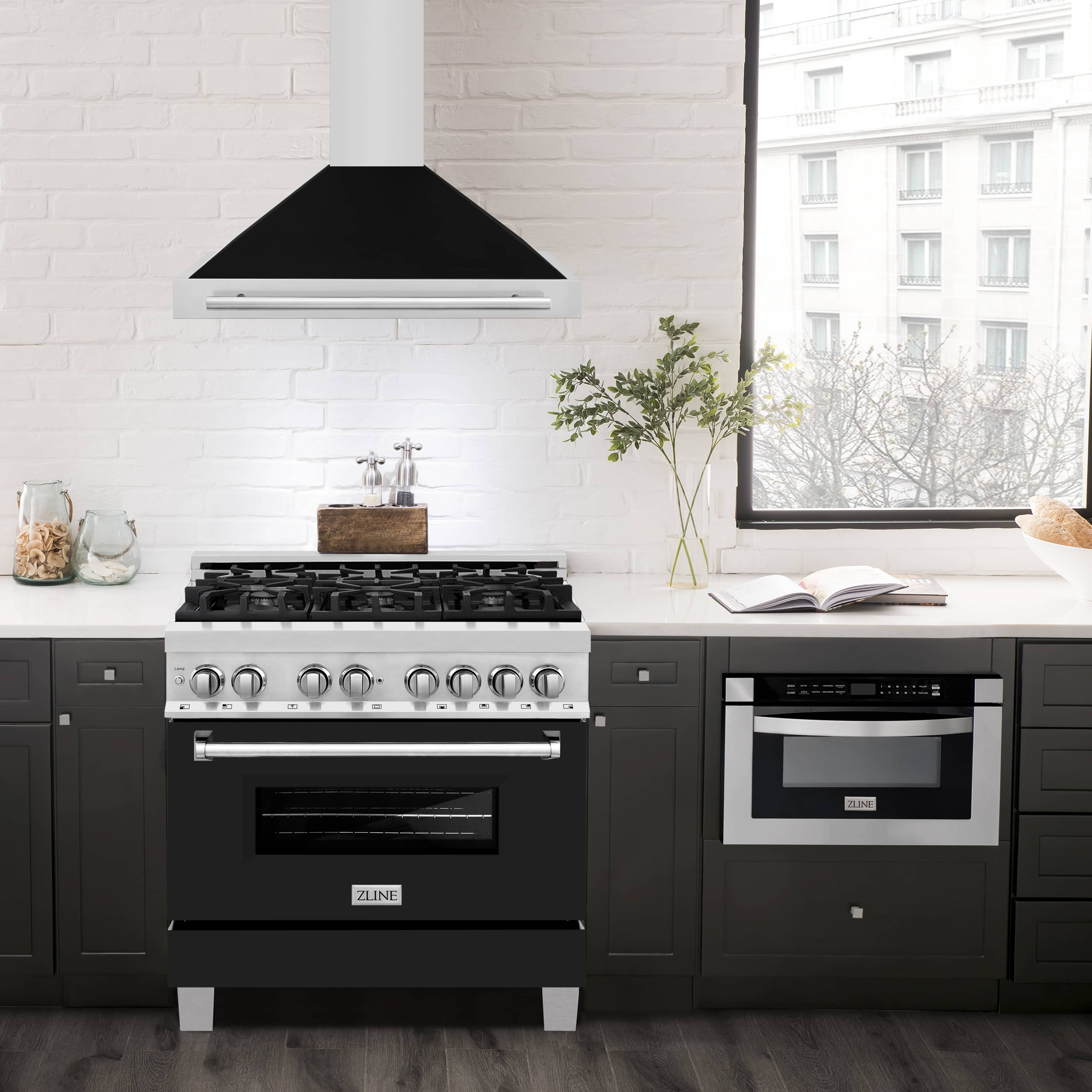 Wall-mounted range hood over a stainless gas range with dark canopy