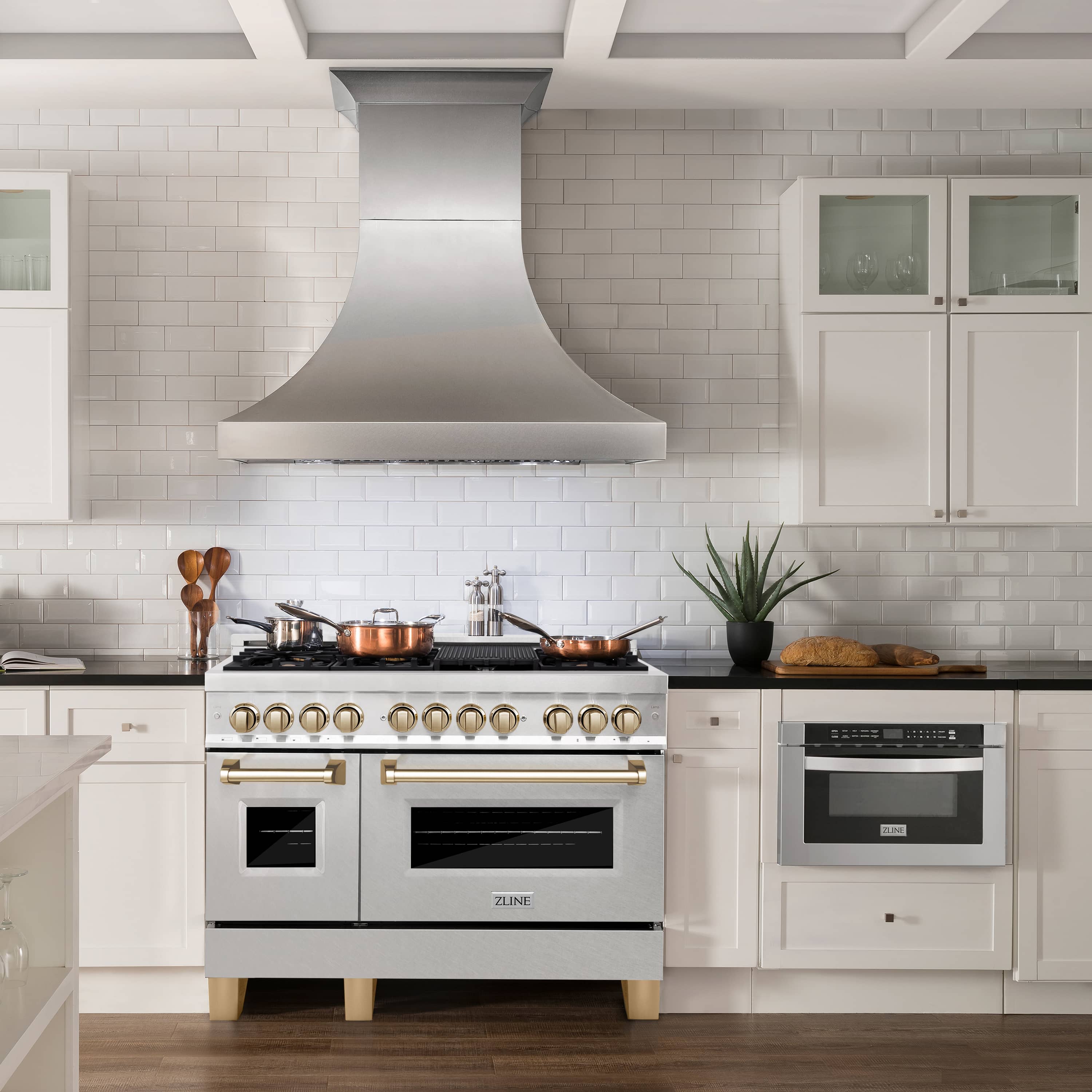 Front view dual fuel range with gold knobs, stainless finish, and double oven