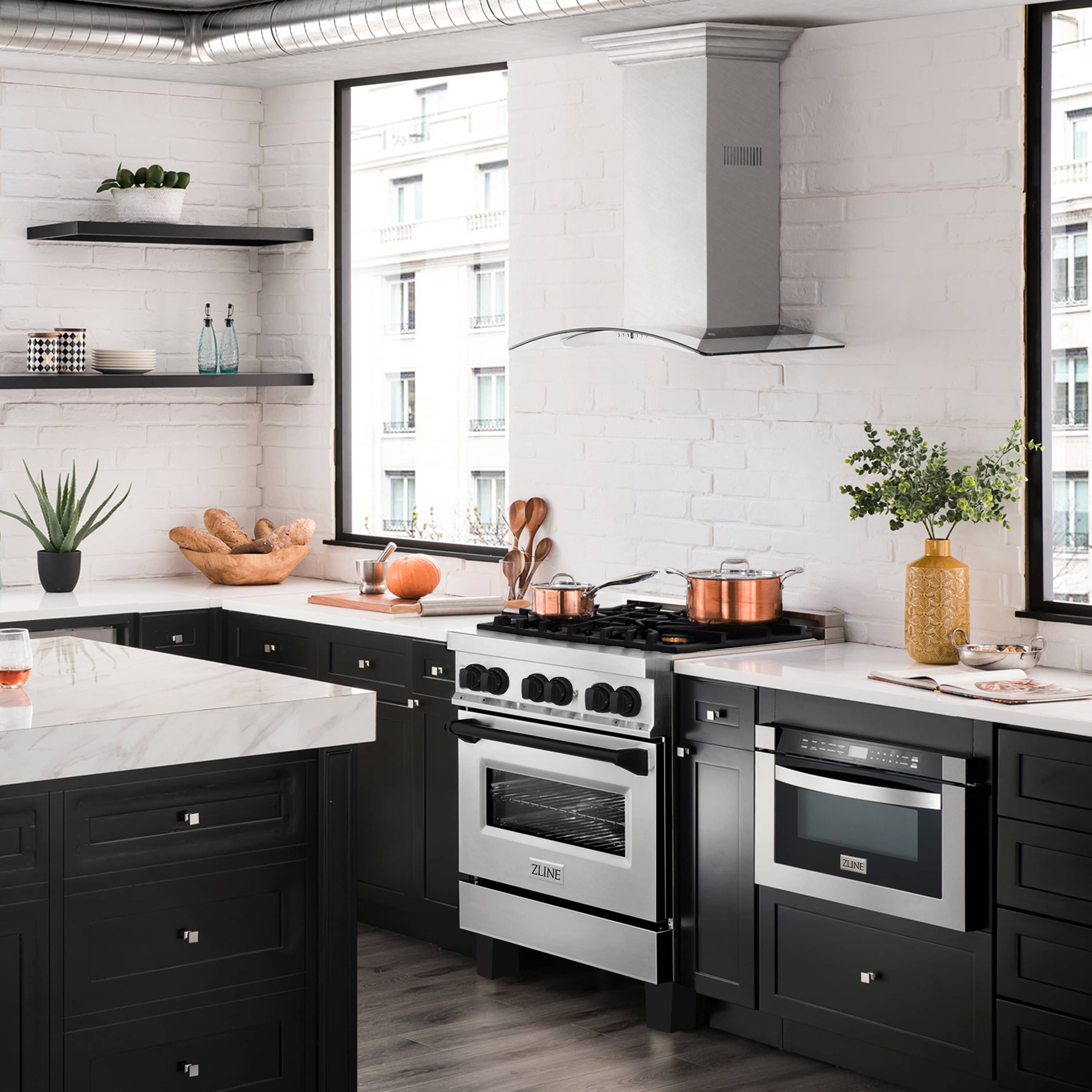 Stainless steel and black dual-fuel range in a modern kitchen with black cabinetry