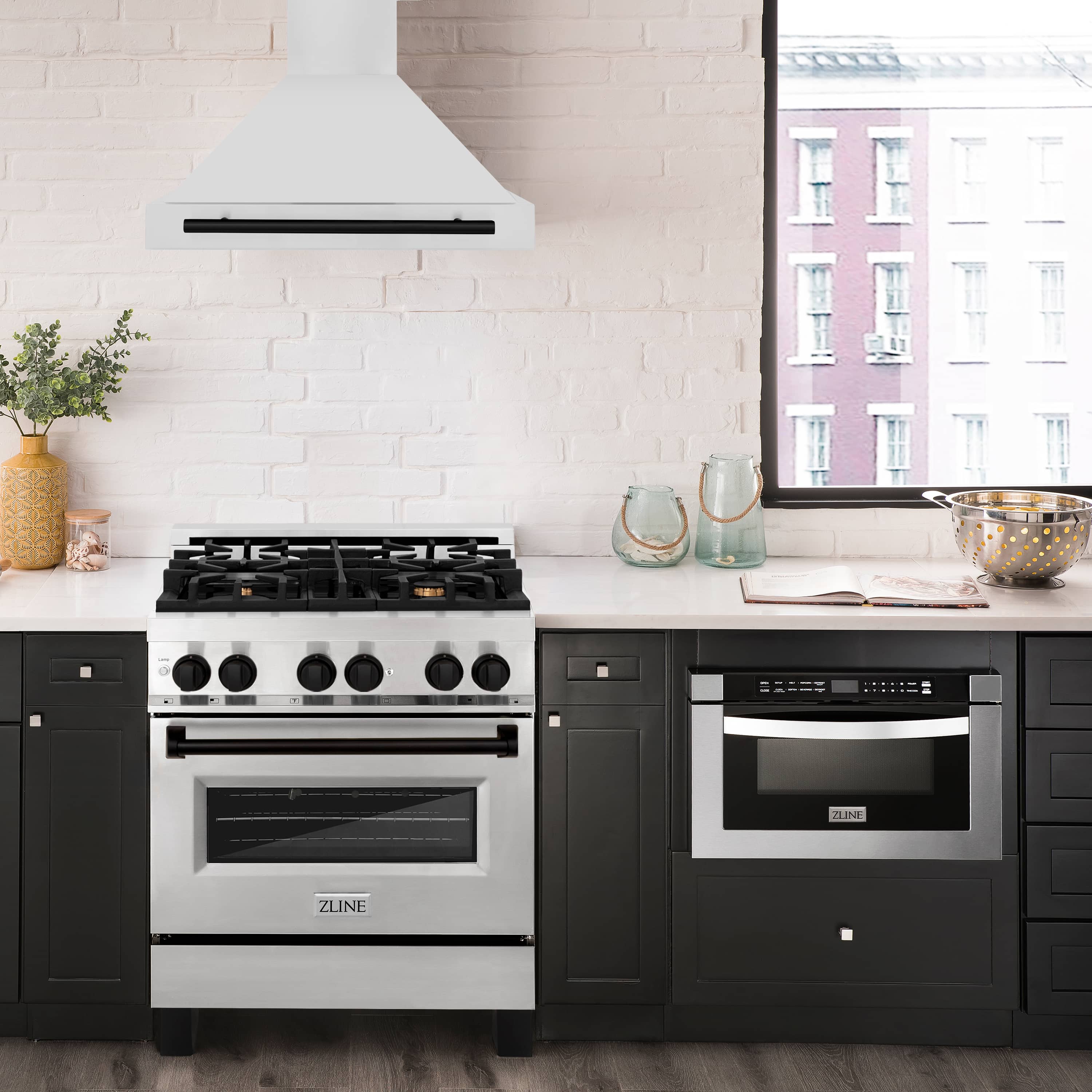 Wall-mounted stainless range hood with matte black vent bar above cooktop.