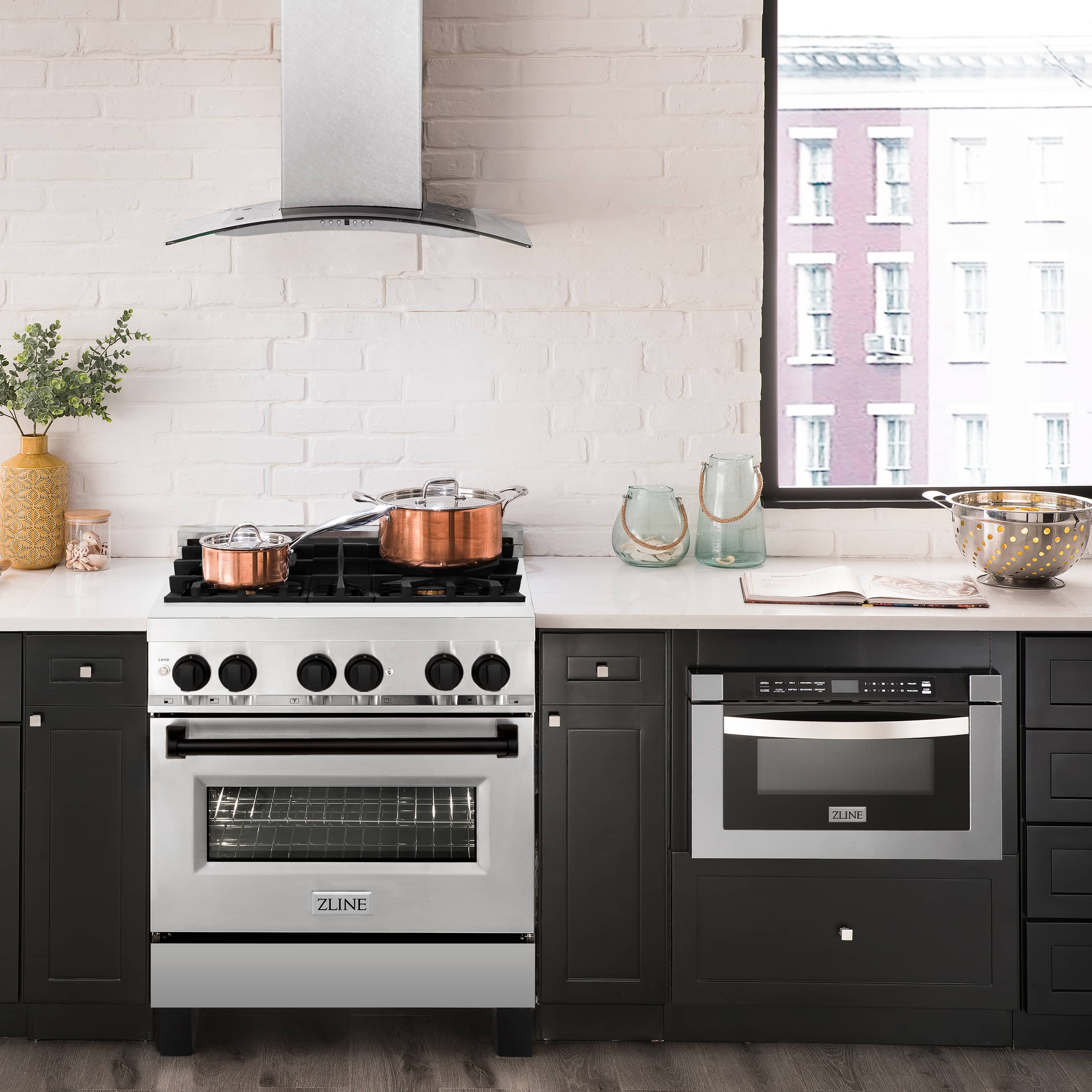 Stainless steel dual-fuel range with black doors and griddle-ready cooktop