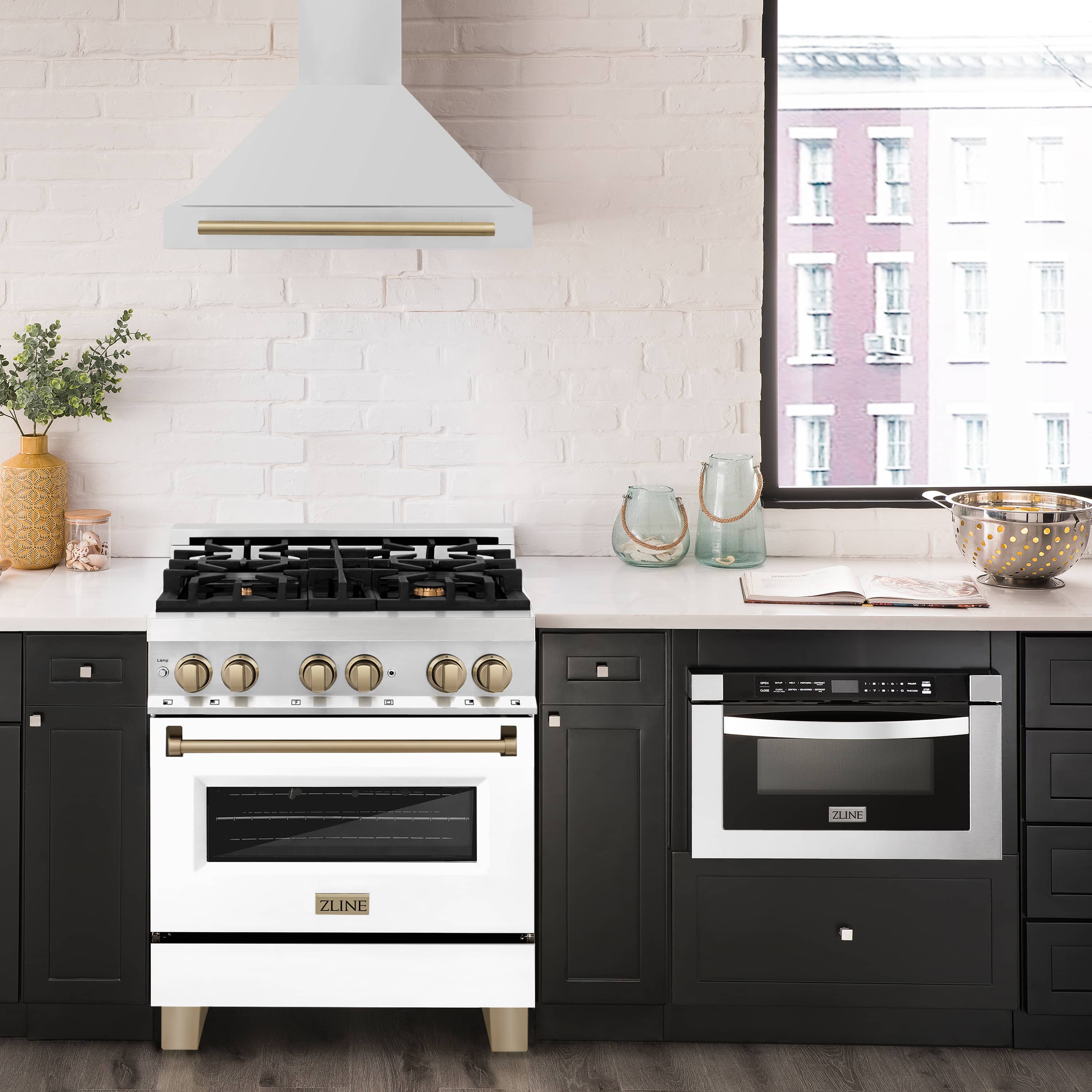 Chimney range hood in white with gold-bronze accent trim above the cooktop