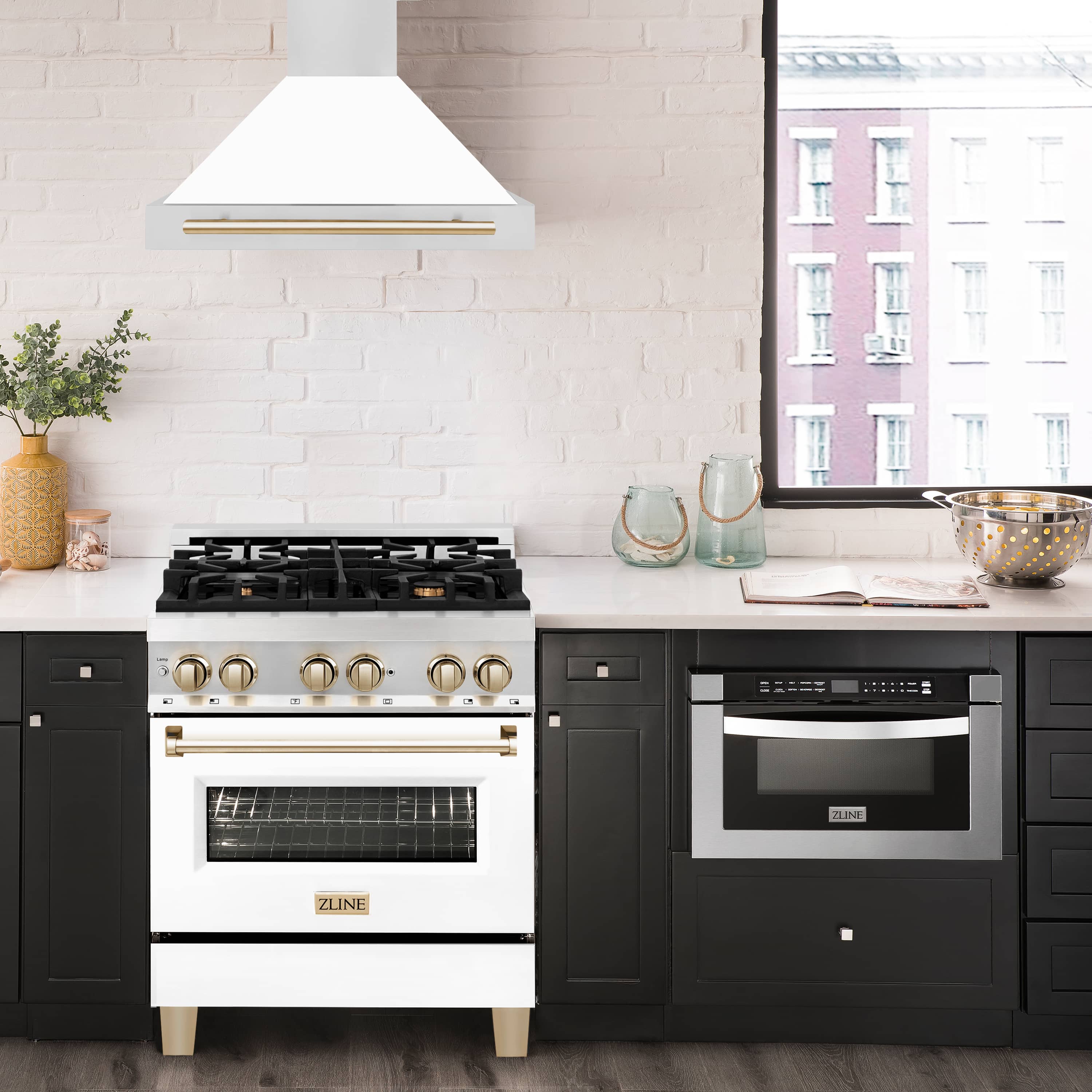 Wall-mounted range hood above gas cooktop, white matte shell with gold bar accents