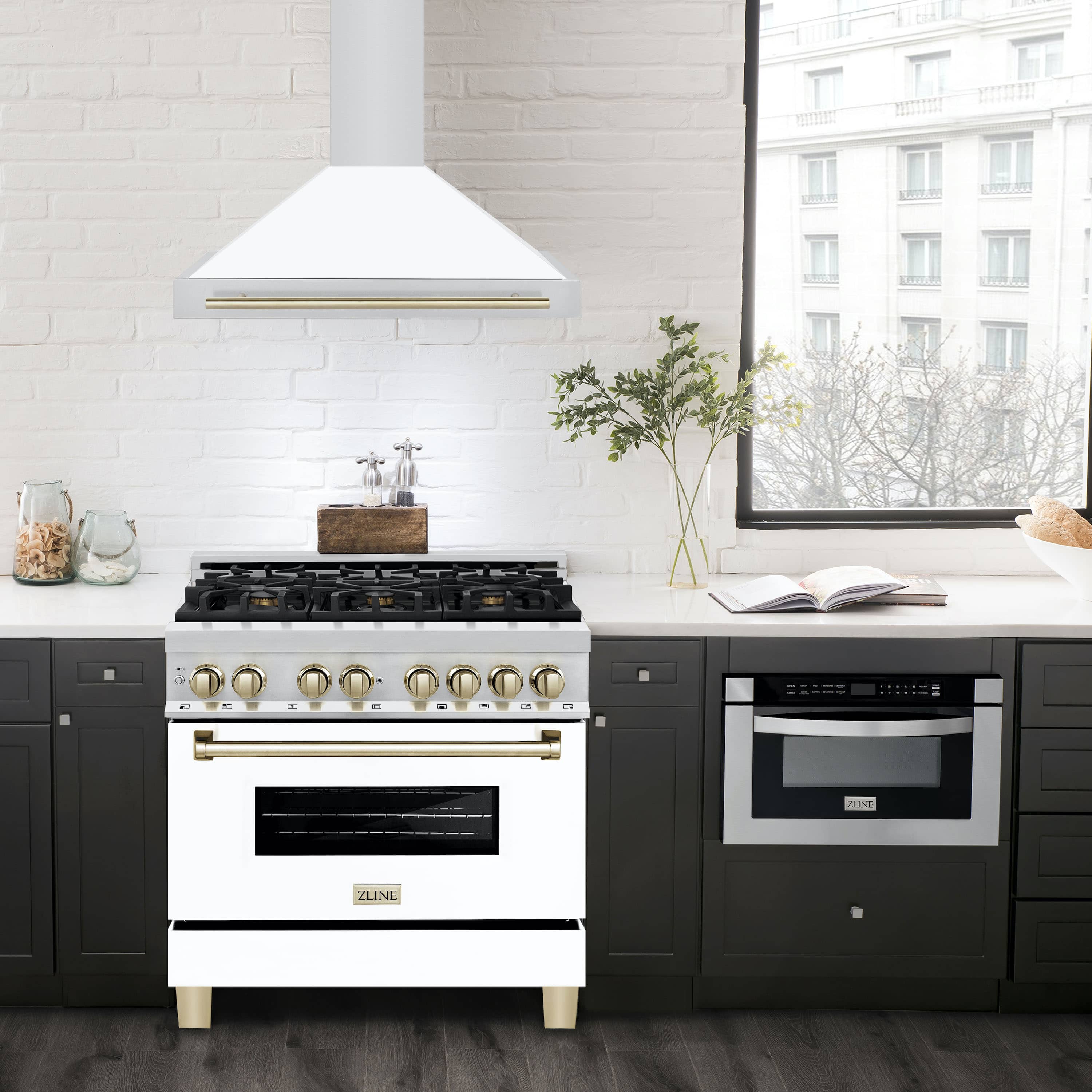 White matte wall-mounted range hood with gold trim bar over a kitchen cooktop