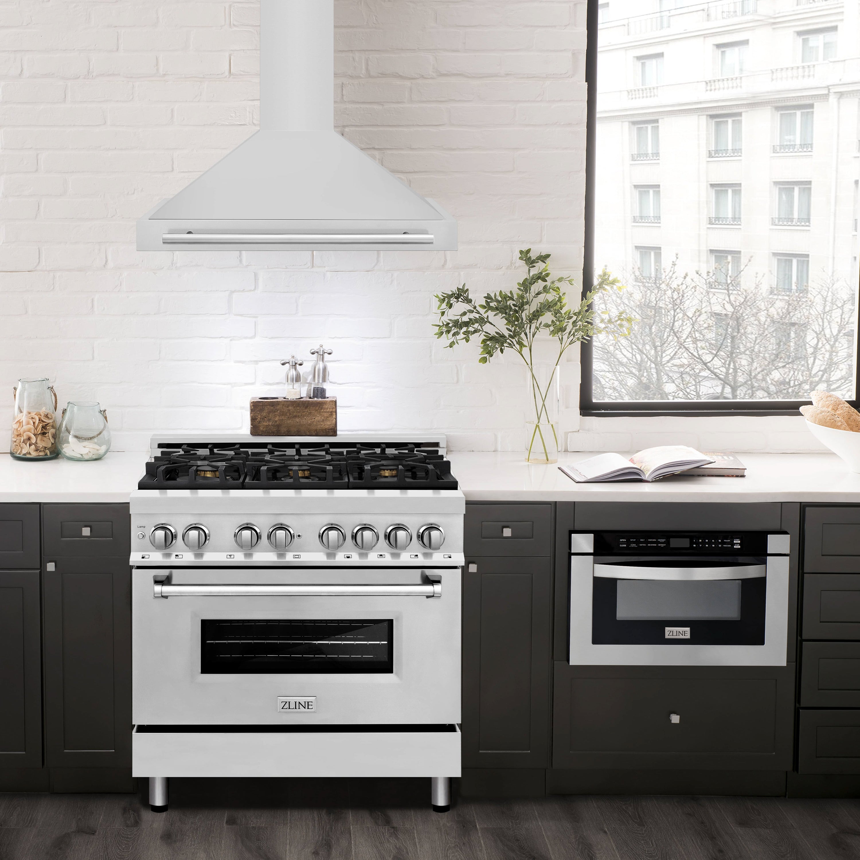 Stainless steel wall-mounted range hood above cooktop with chimney vent