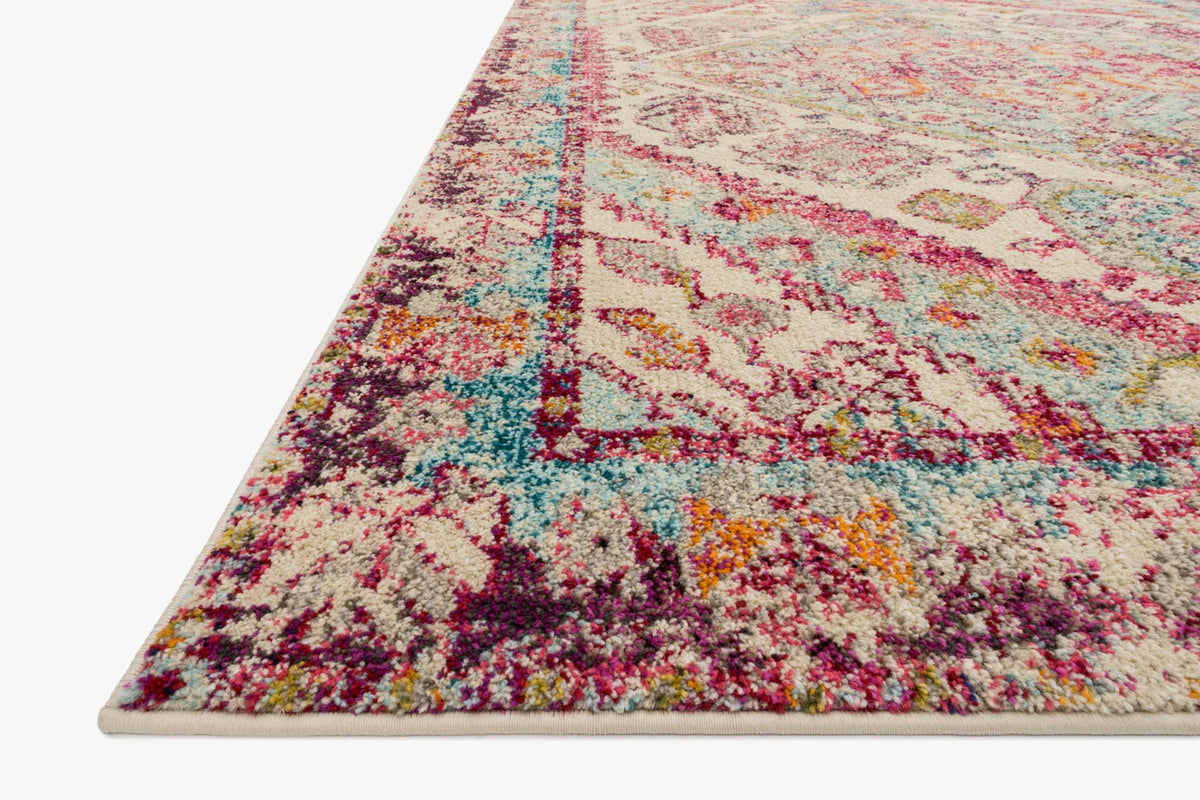 Corner view of transitional rug with aqua, pink, and ivory ornate pattern and border.