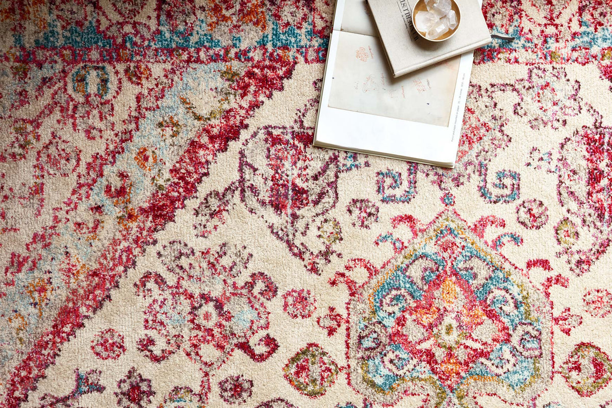 Transitional power-loomed rug close-up with aqua and pink intricate motif