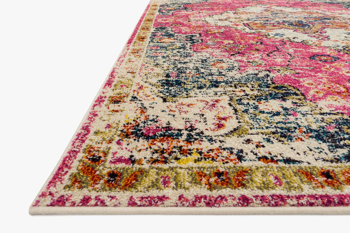 Pink and dark navy area rug, angled view showing detailed distressed texture
