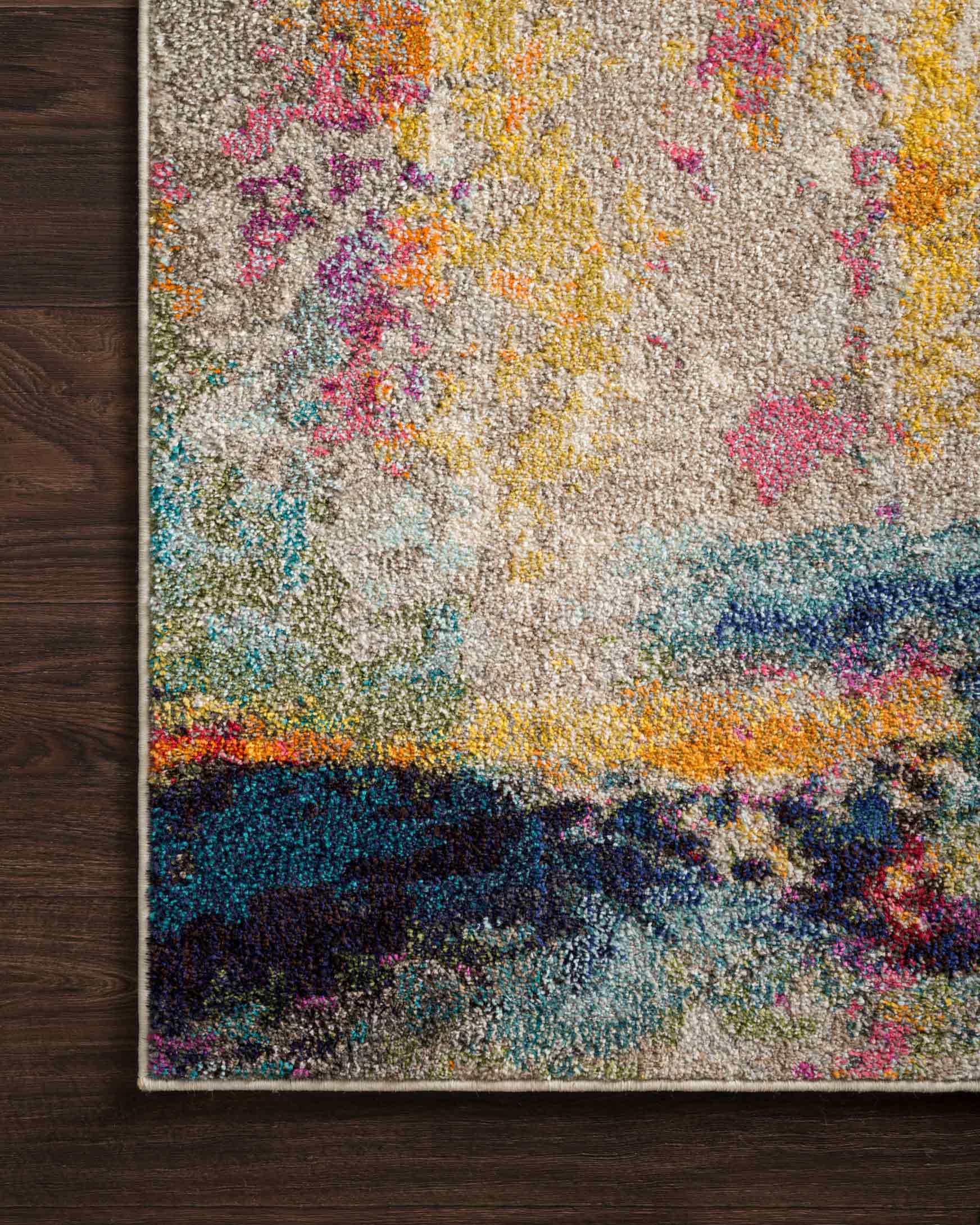 Multicolor abstract rug on dark wood floor, flat corner view