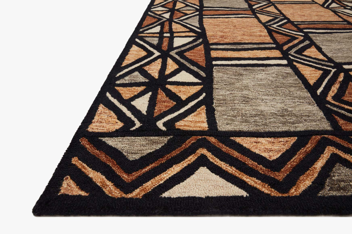 Hand-tufted rug corner with black border, chevrons, and diamond shapes in tan and brown
