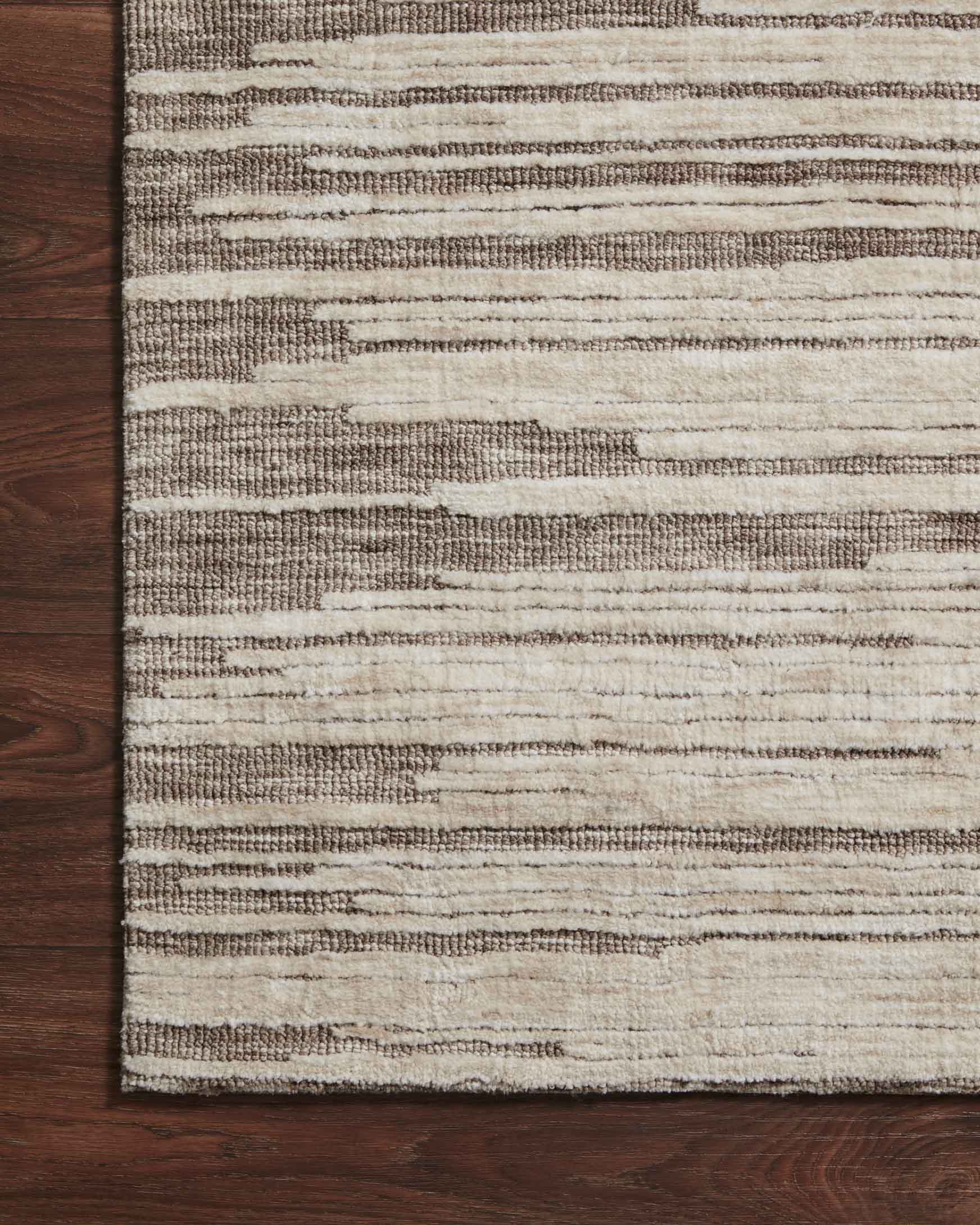 Taupe and stone rug with tightly woven horizontal stripes and bordered edge
