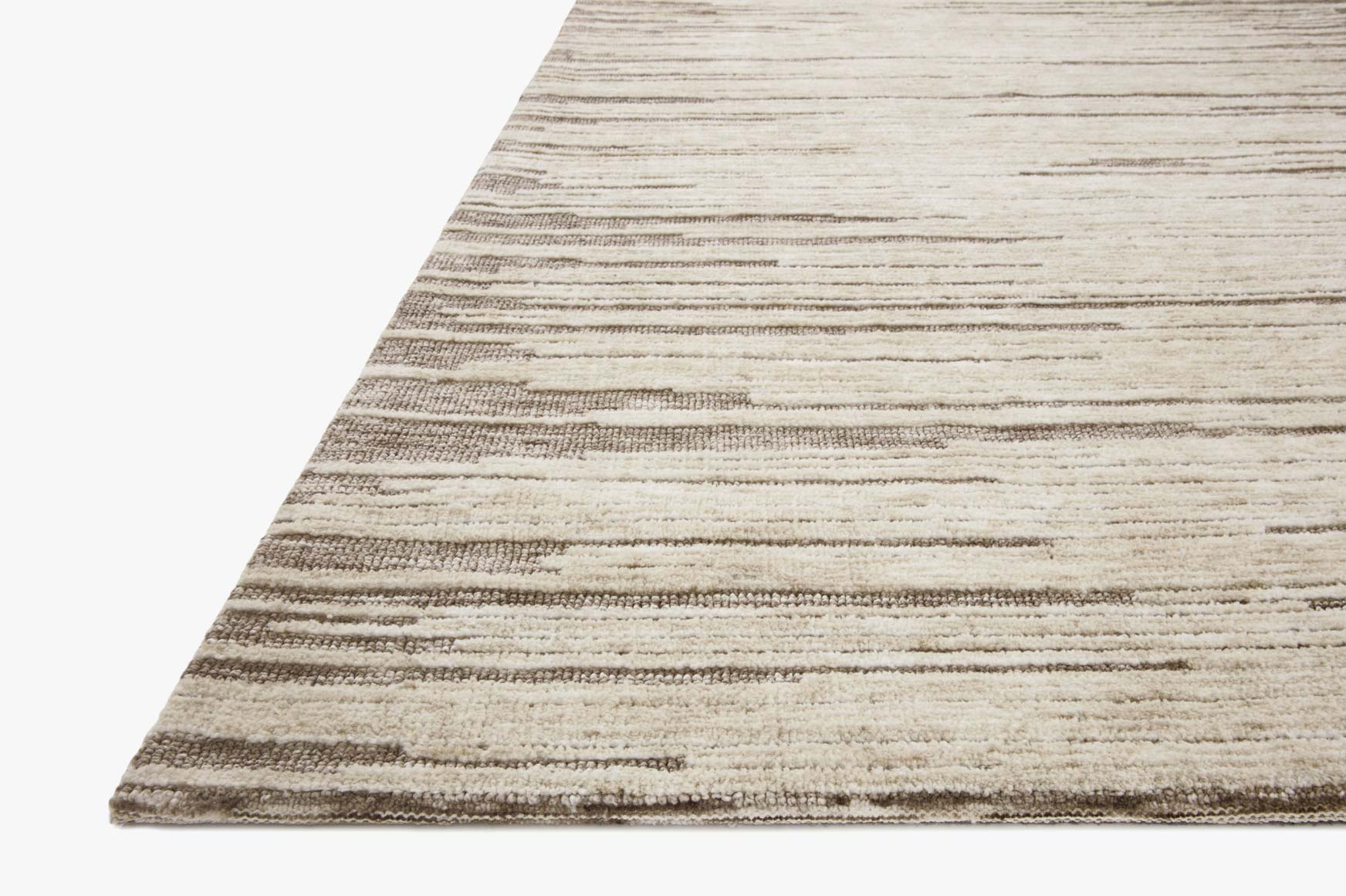 Taupe and stone rug corner with layered horizontal stripes and low pile