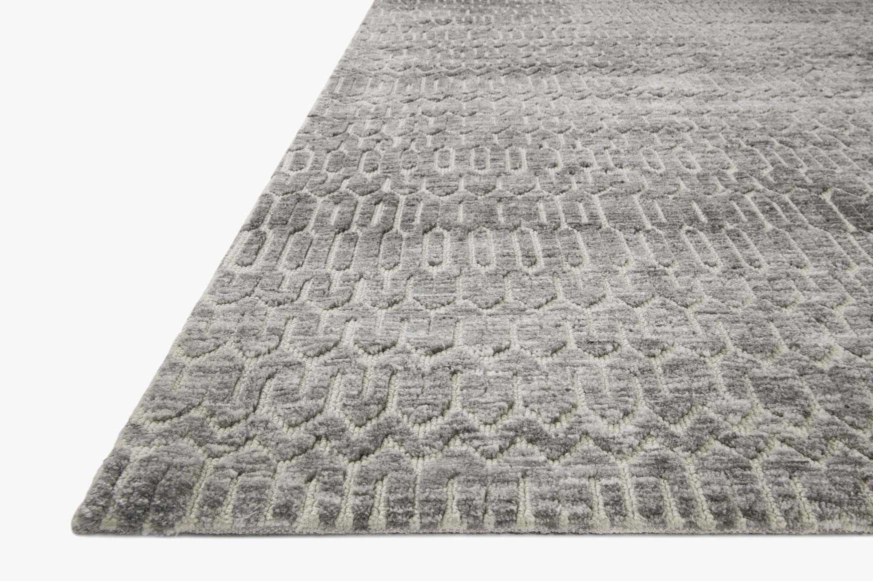 Corner view of ivory and charcoal geometric power-loomed area rug