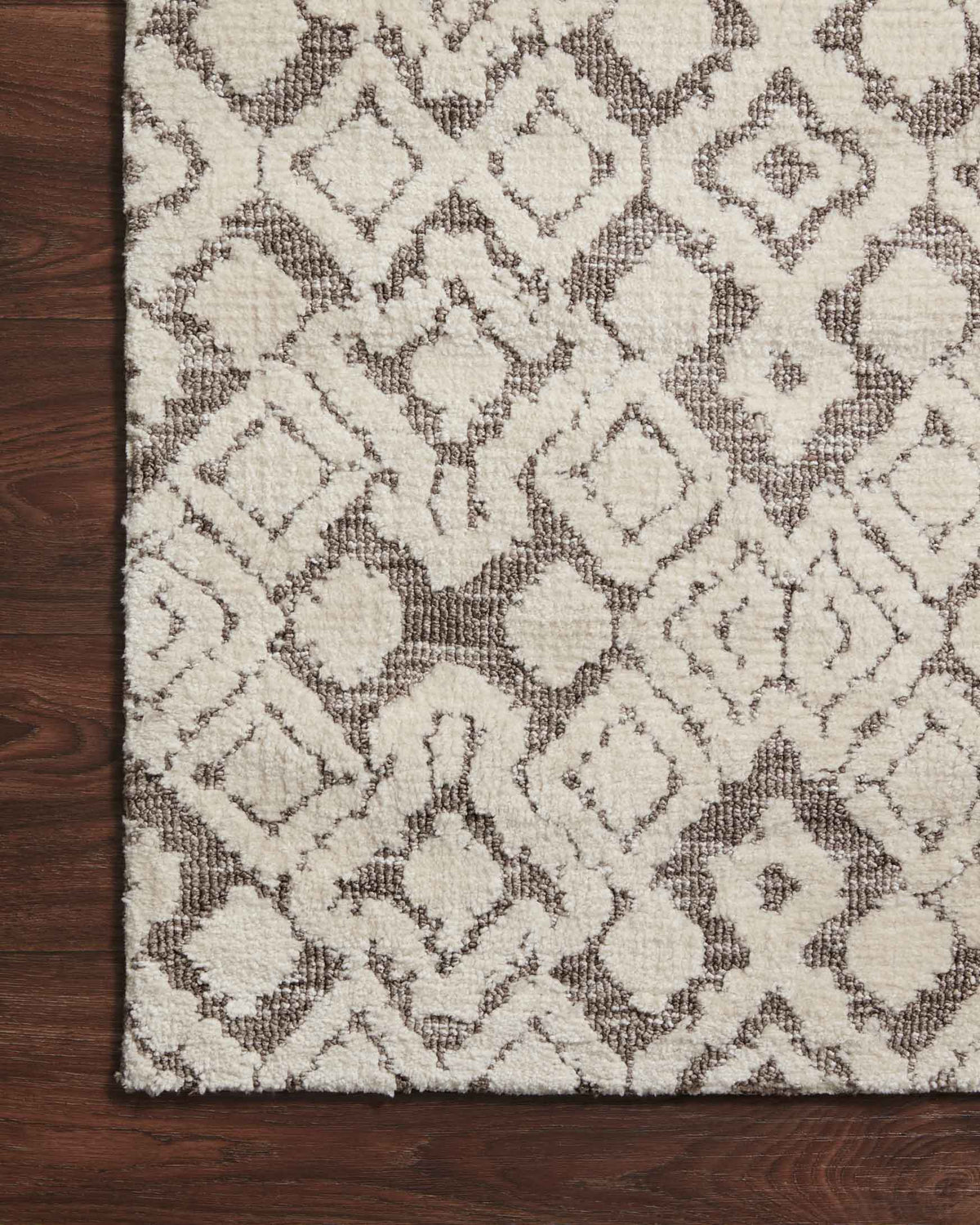 Close-up of transitional power-loomed rug: ivory ground with dark gray geometric motifs